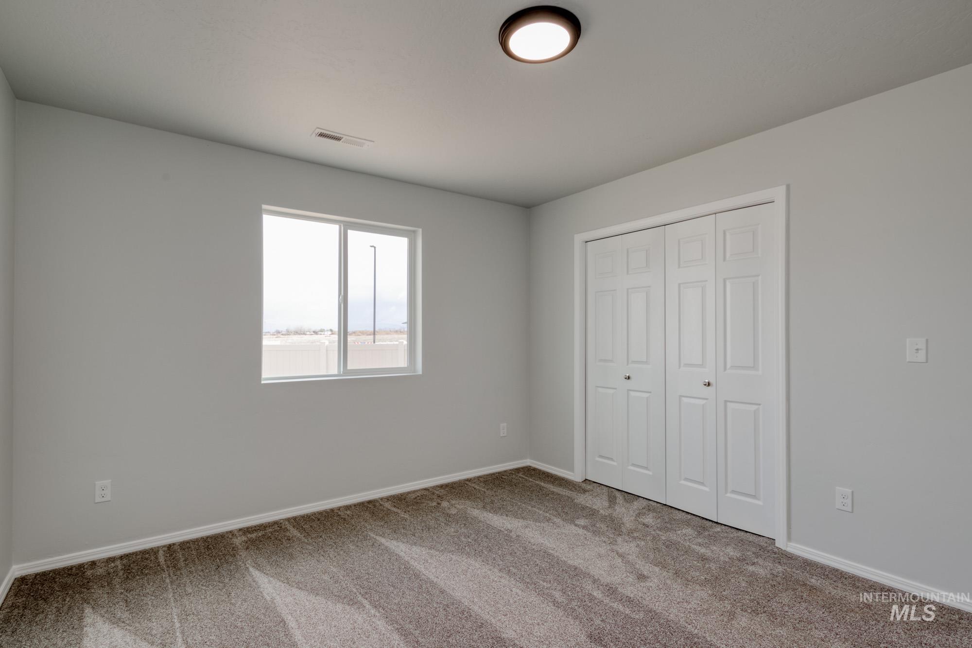 Unfurnished bedroom featuring carpet flooring and a closet