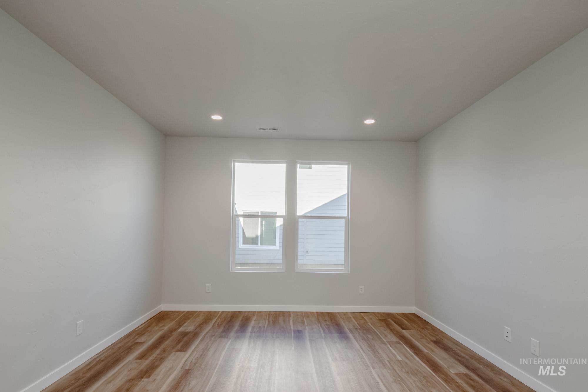 Unfurnished room featuring light wood finished floors and recessed lighting