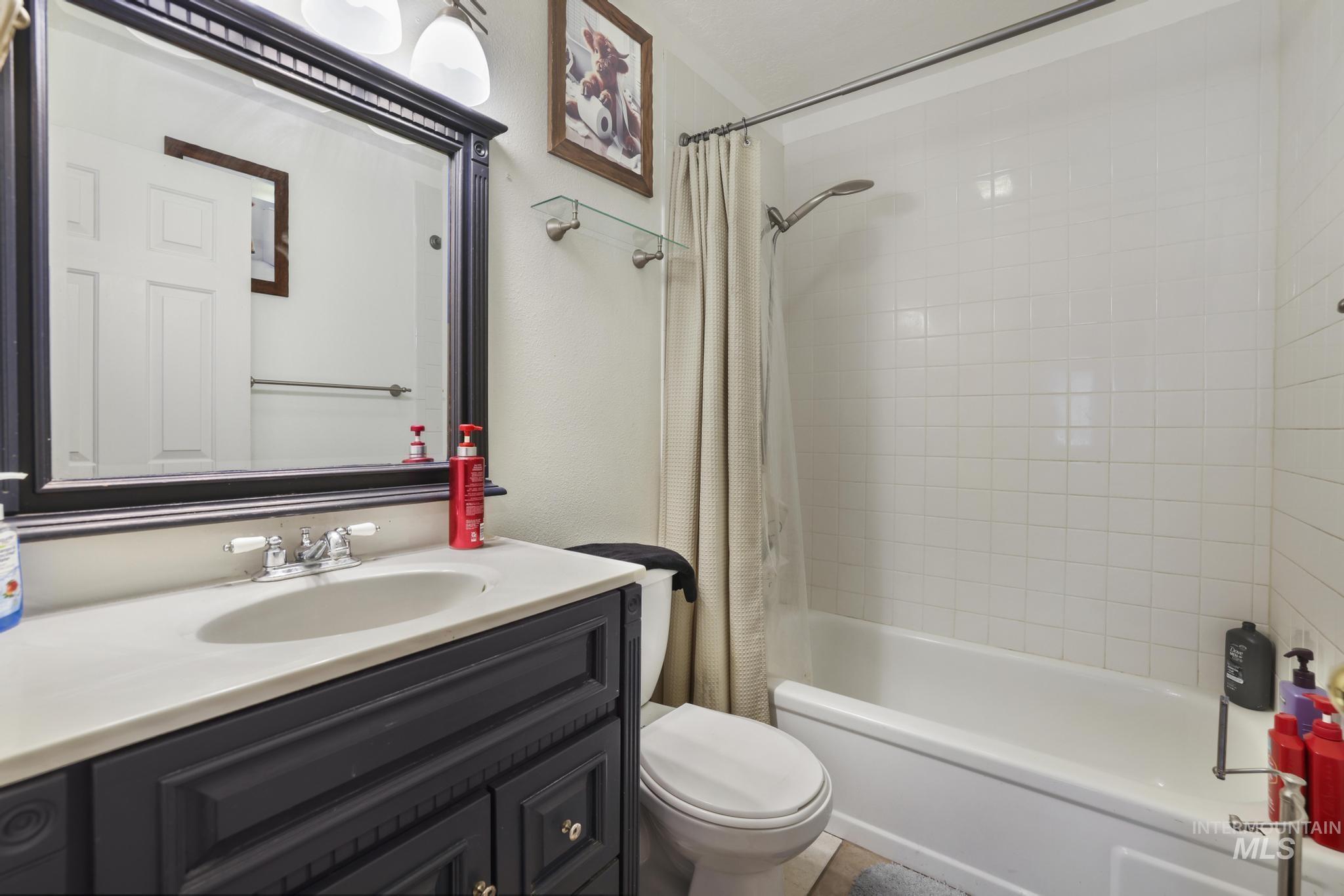 Bathroom featuring shower / bath combo and vanity