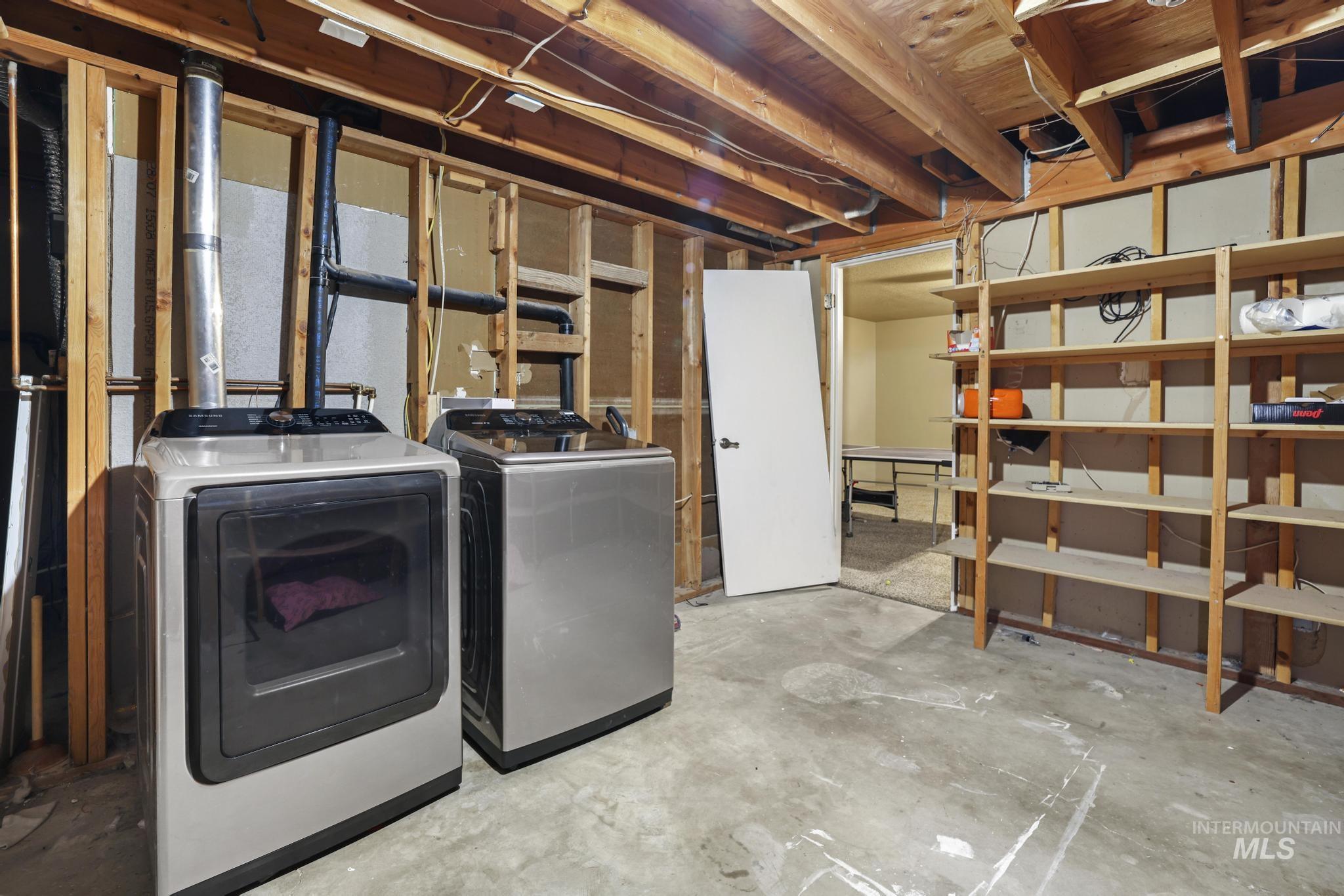 Unfinished basement with washing machine and dryer