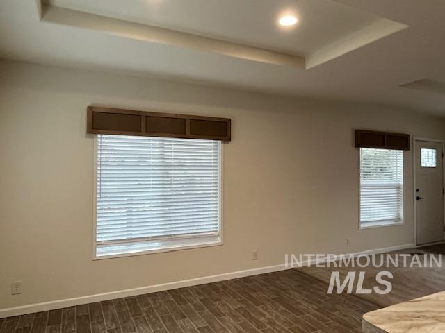 Dining room with a tray ceiling and recessed lighting