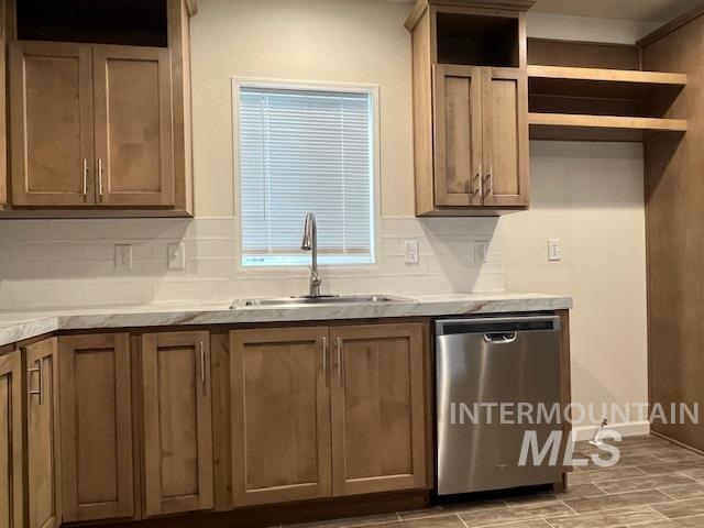 Kitchen with backsplash, dishwasher, brown cabinetry, and wood tiled floors