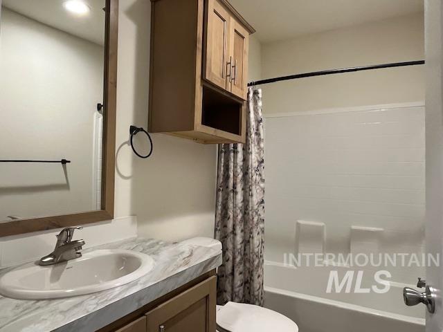 Bathroom featuring shower / tub combo and vanity