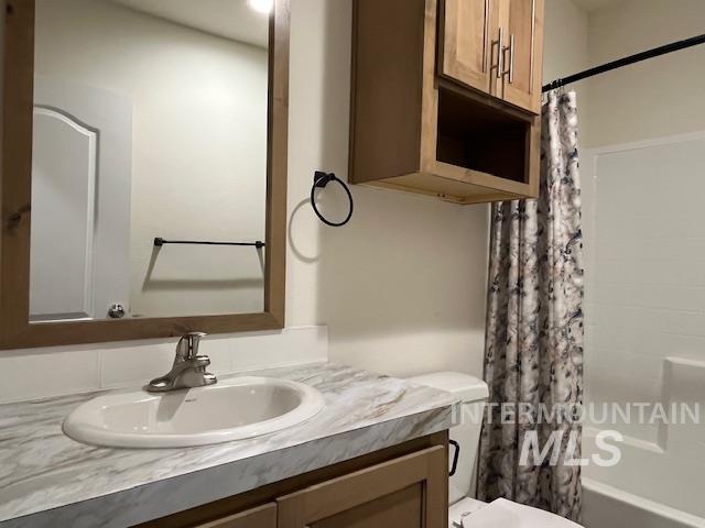 Full bath featuring vanity and shower / tub combo