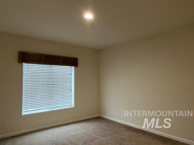 Unfurnished room featuring carpet flooring and baseboards