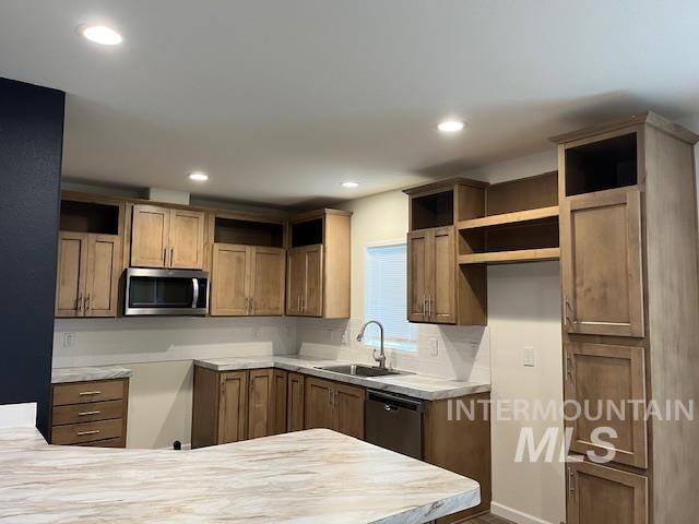 Kitchen with brown cabinetry, light countertops, open shelves, stainless steel appliances, and recessed lighting