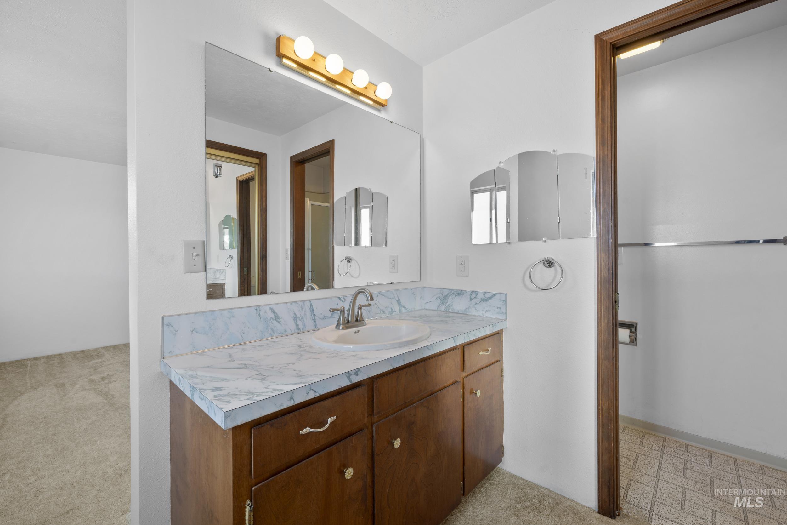 Bathroom featuring vanity and light floors