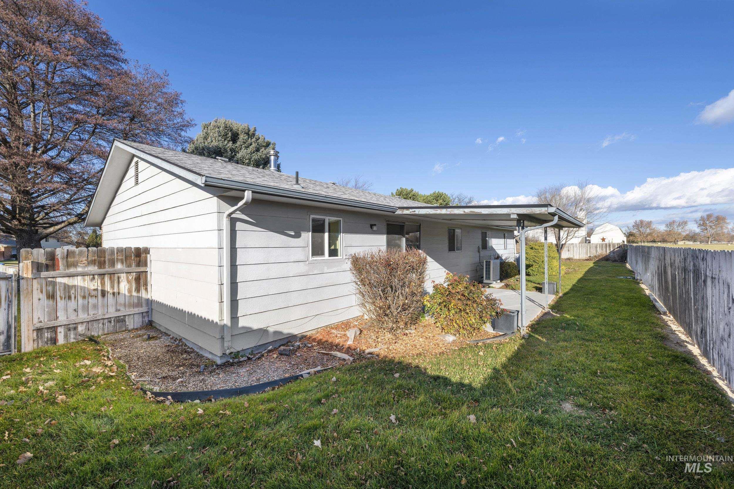 Back of property with a fenced backyard and a patio