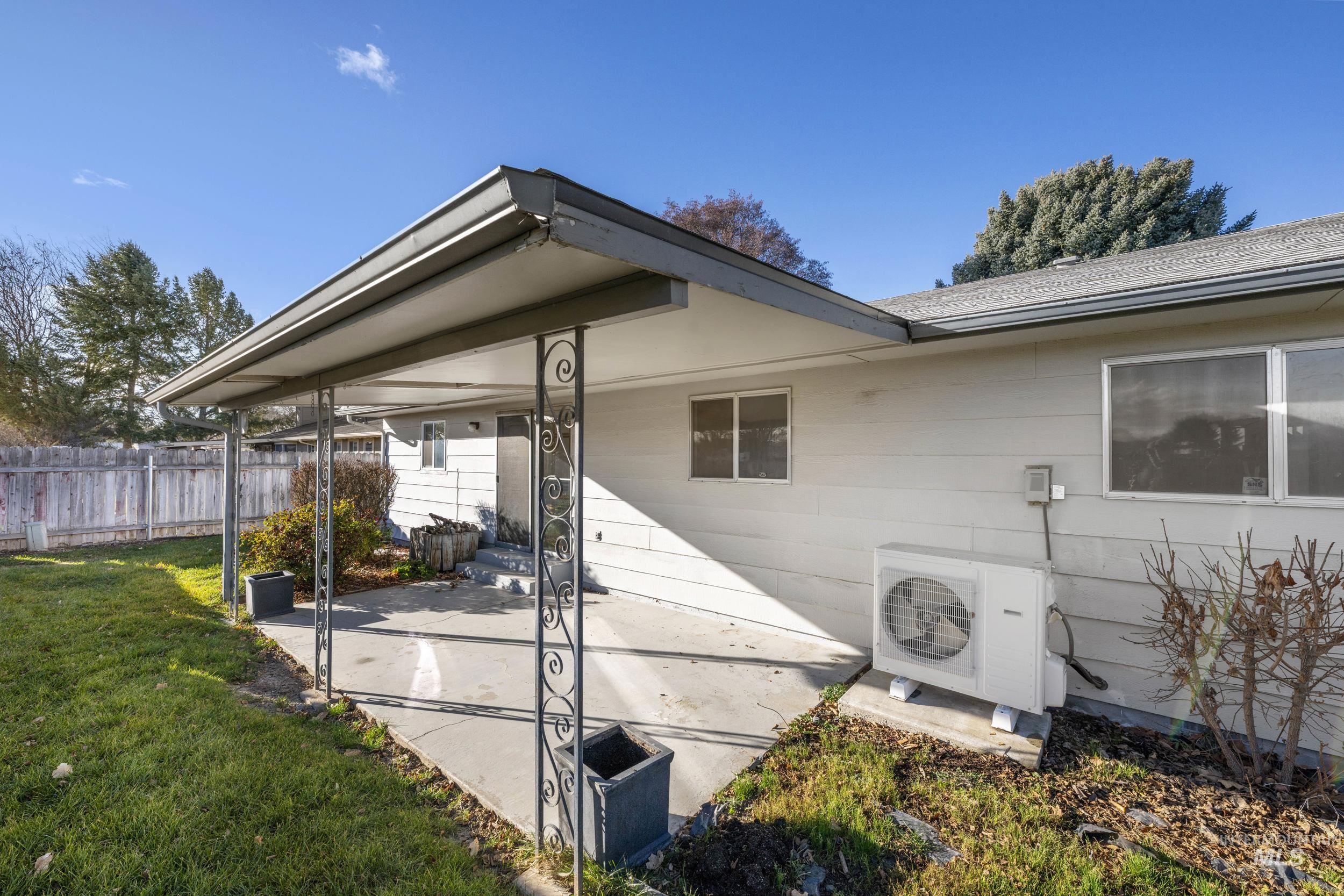 View of property exterior with a patio area and roof with shingles