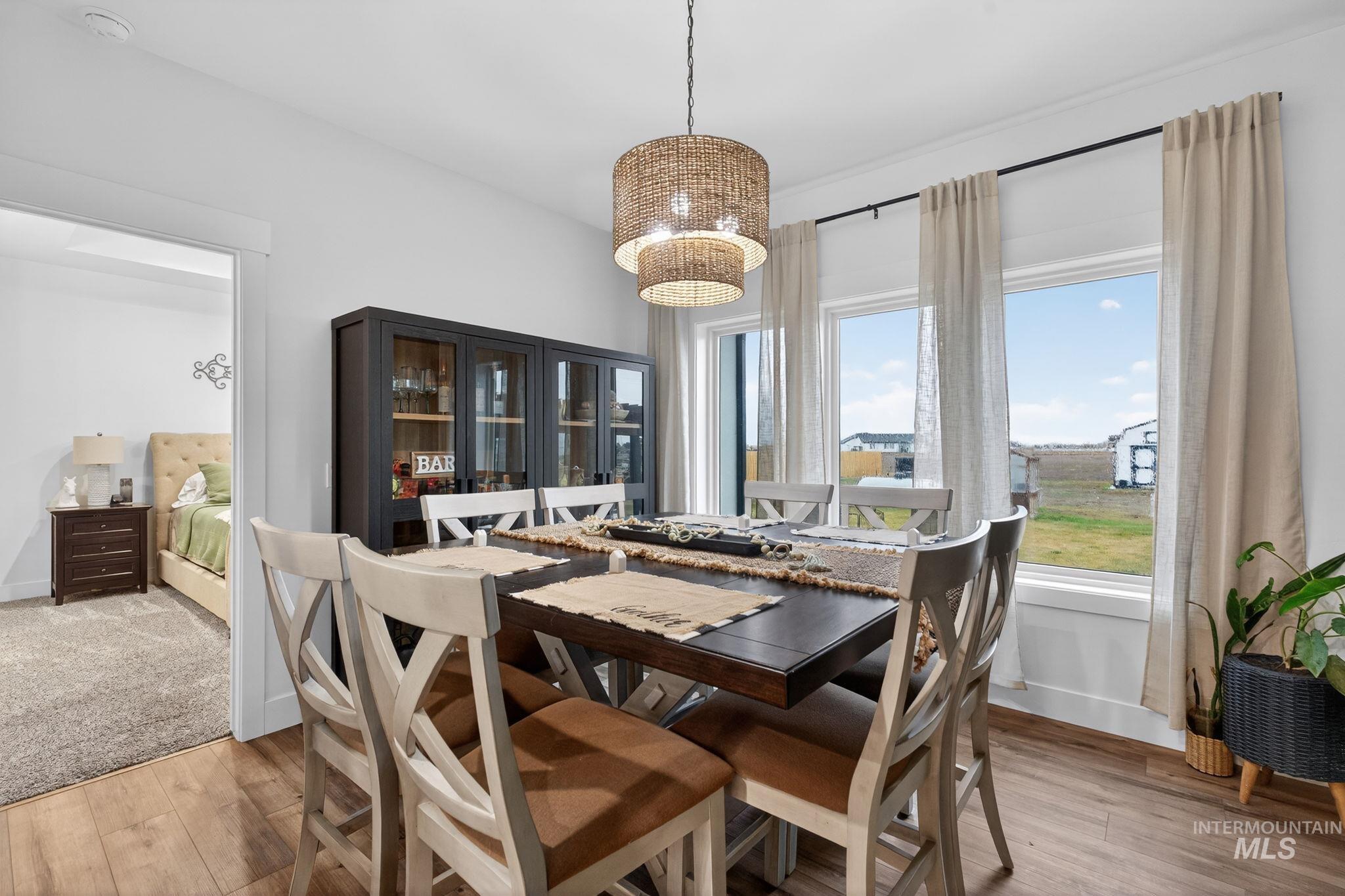 Dining room with light wood-type flooring and baseboards