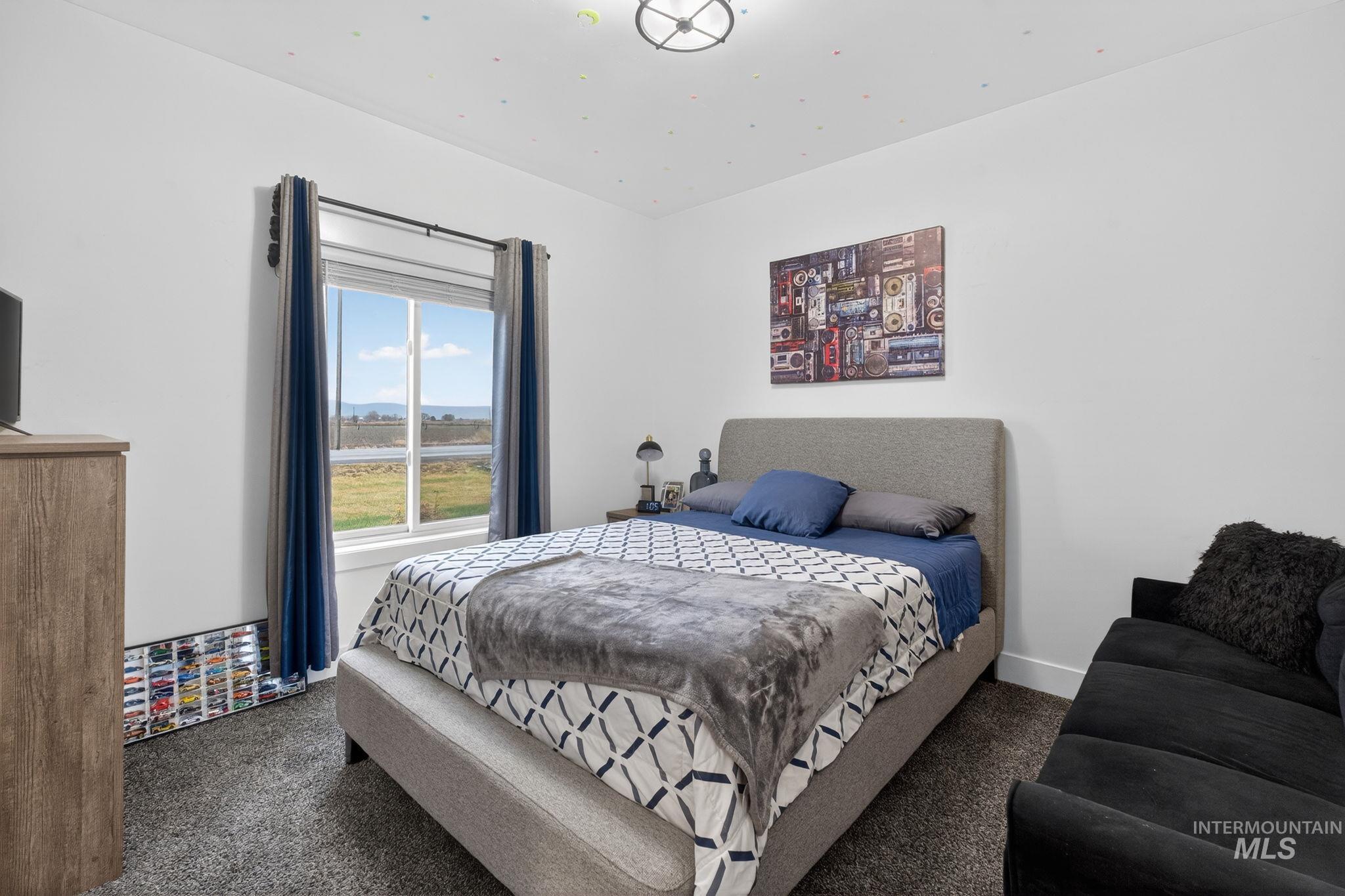 Bedroom featuring carpet and baseboards