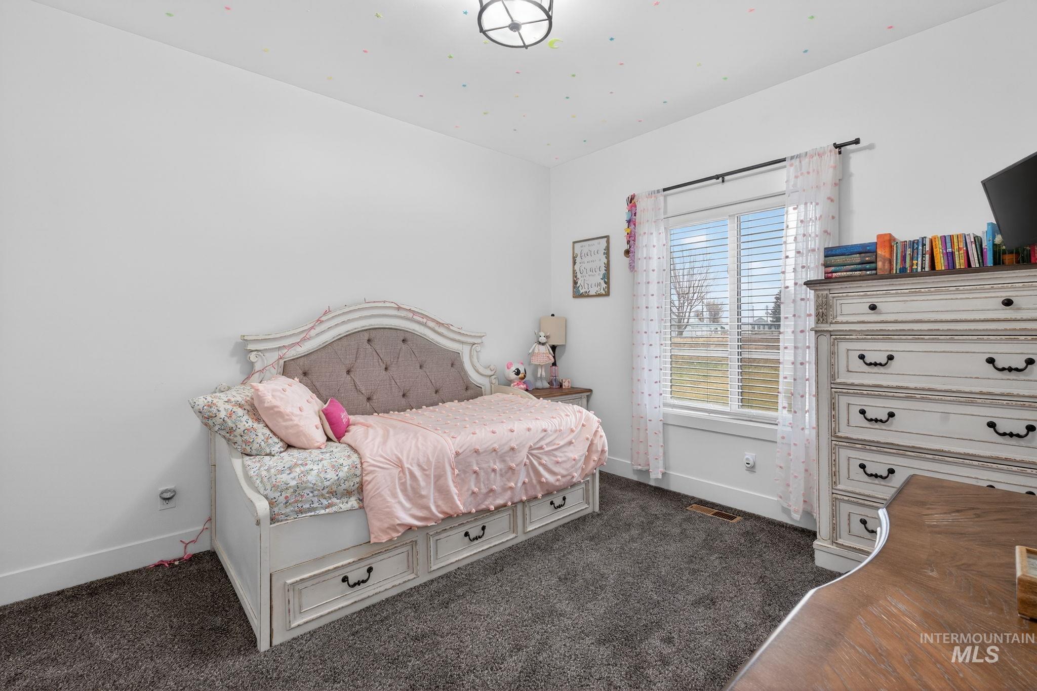 Bedroom with dark carpet