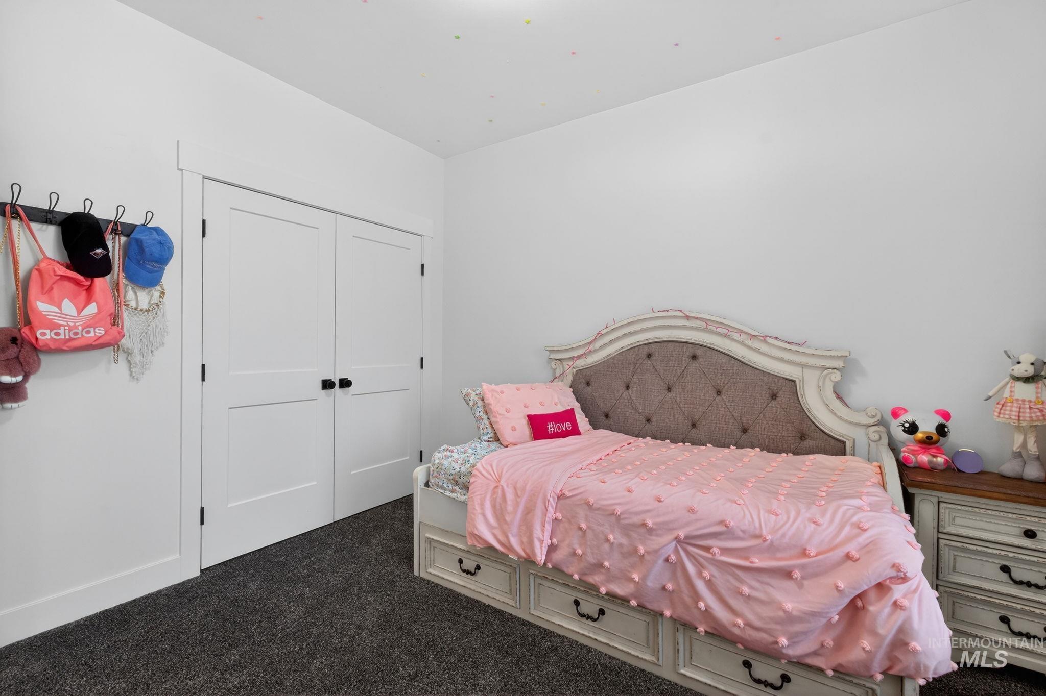 Bedroom featuring dark carpet and a closet