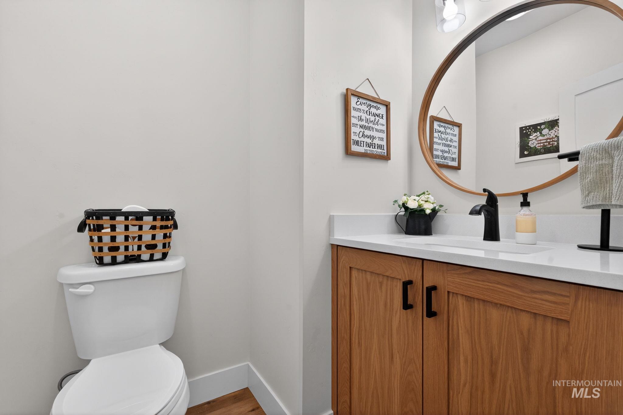 Half bath featuring vanity and light wood-style floors