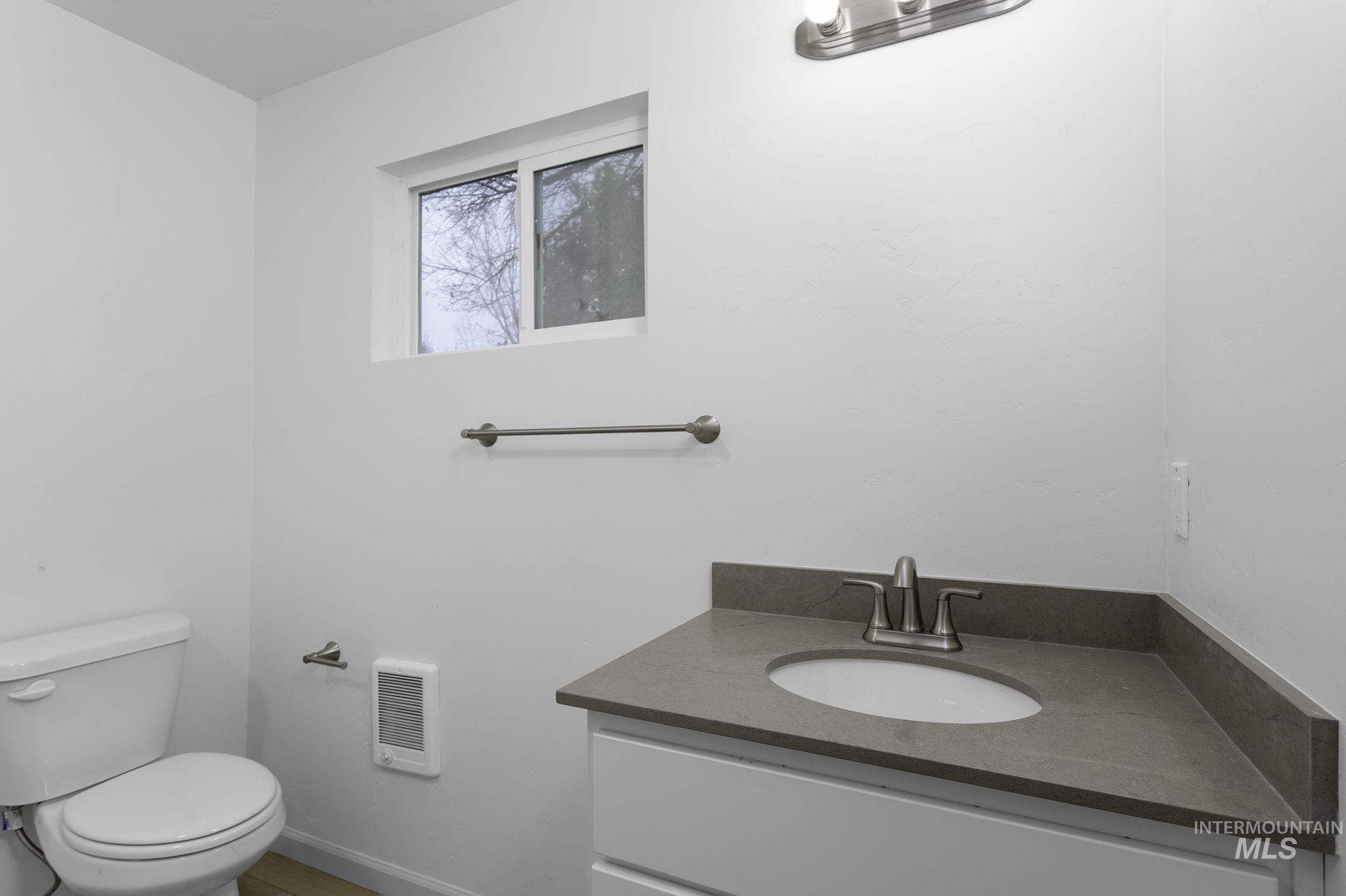 Bathroom featuring vanity and heating unit