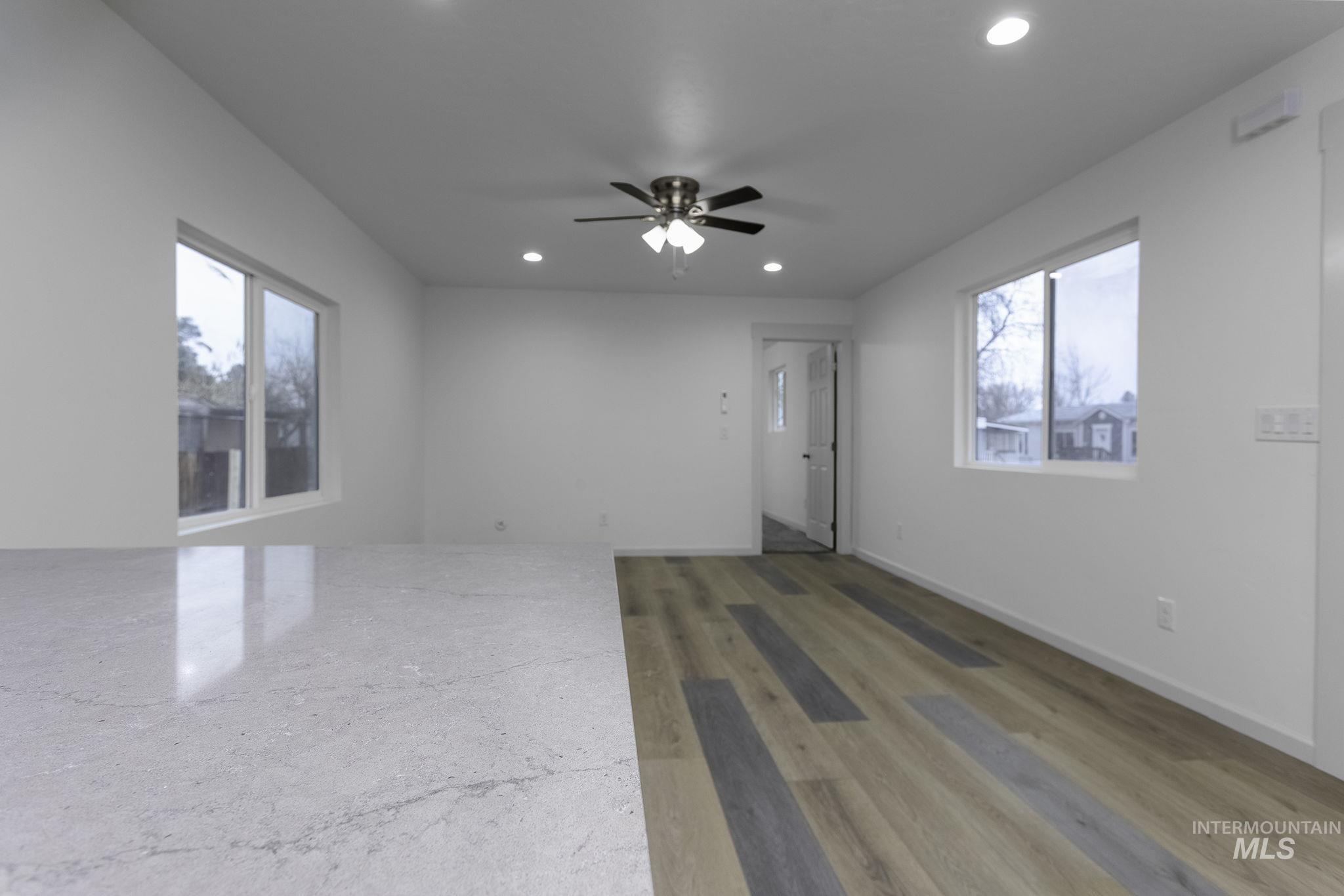 Unfurnished room with a ceiling fan, light wood finished floors, recessed lighting, and plenty of natural light