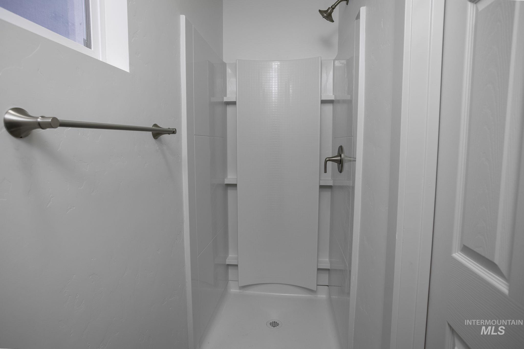 Bathroom featuring a shower stall