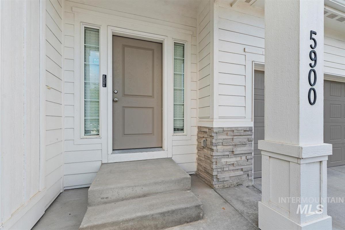 Entrance to property featuring stone siding
