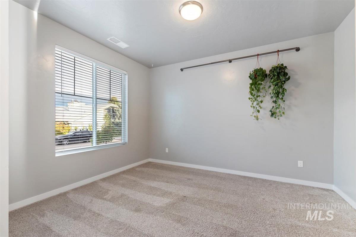 Unfurnished room featuring light colored carpet and baseboards