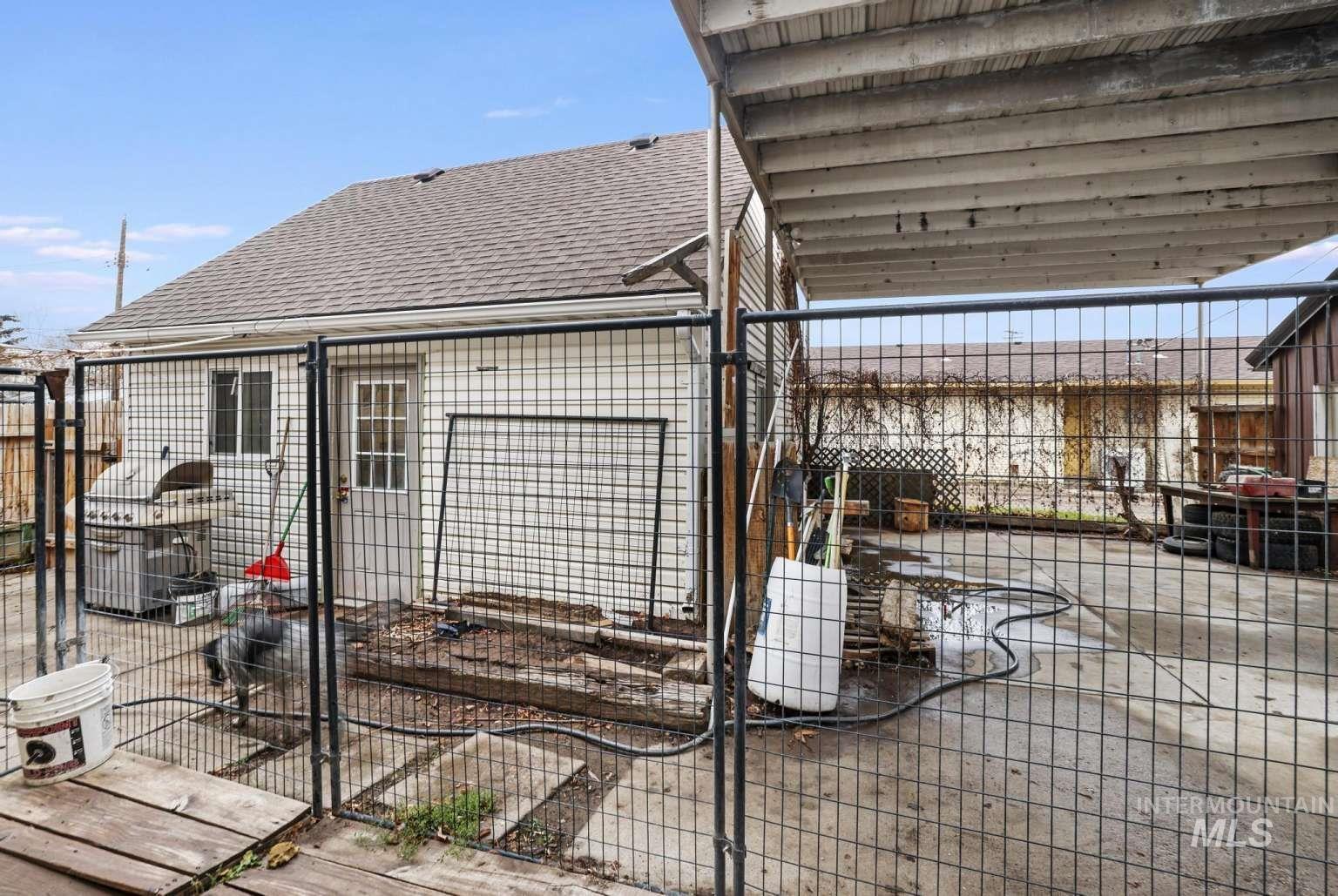 View of property exterior with an exterior structure, roof with shingles, and an outdoor structure