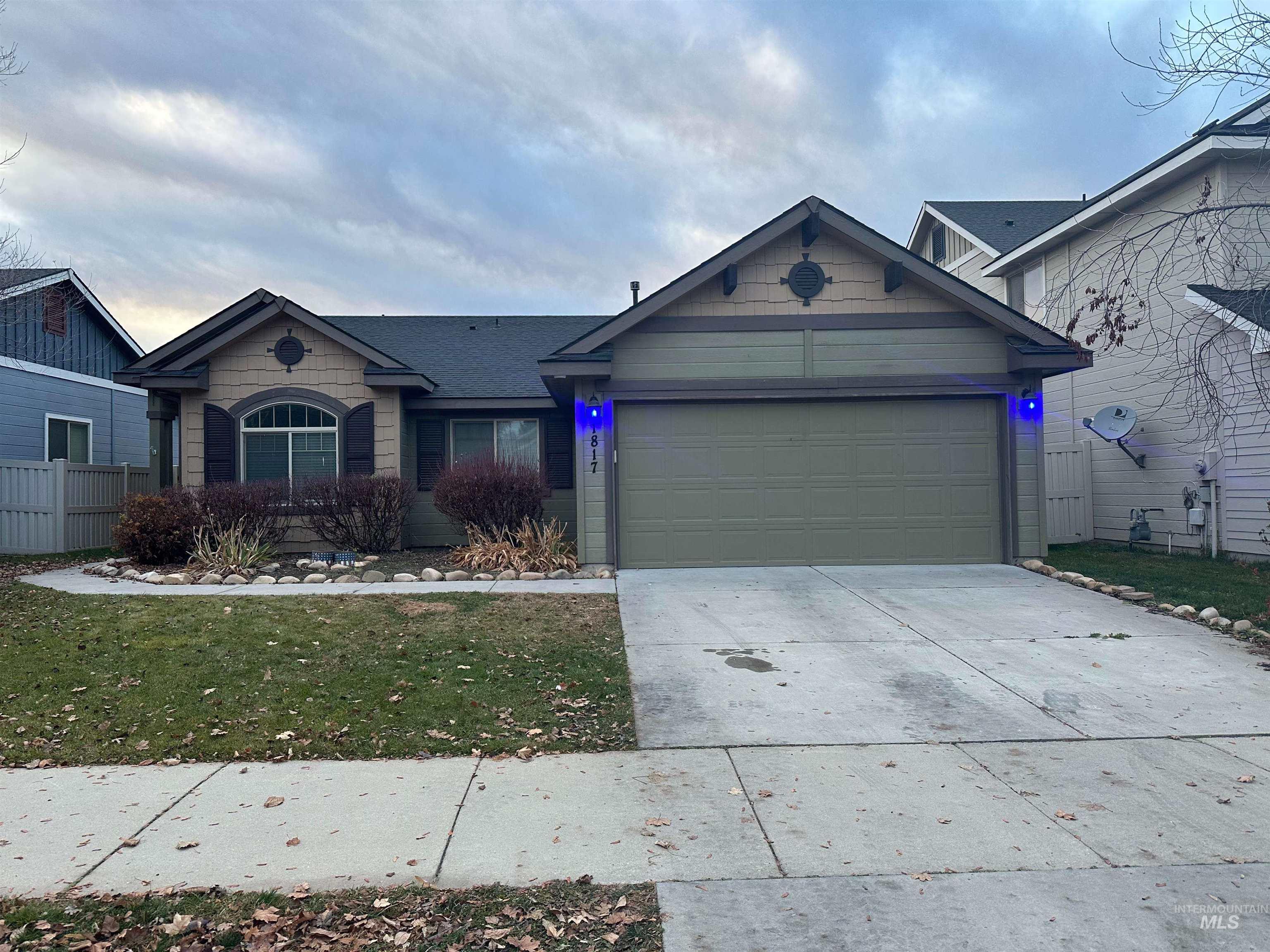 View of front of property featuring concrete driveway and a garage