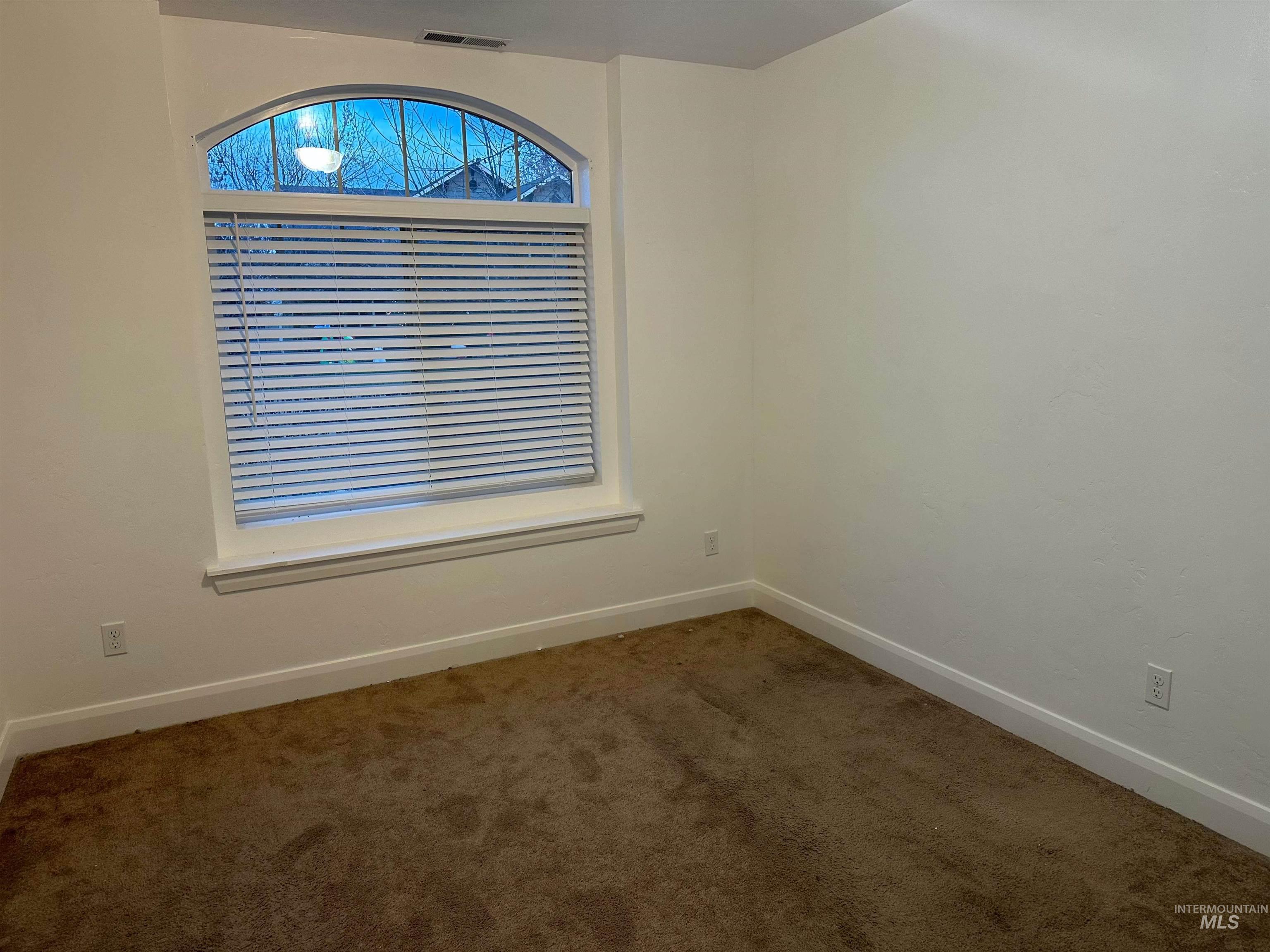 Unfurnished room with carpet and baseboards