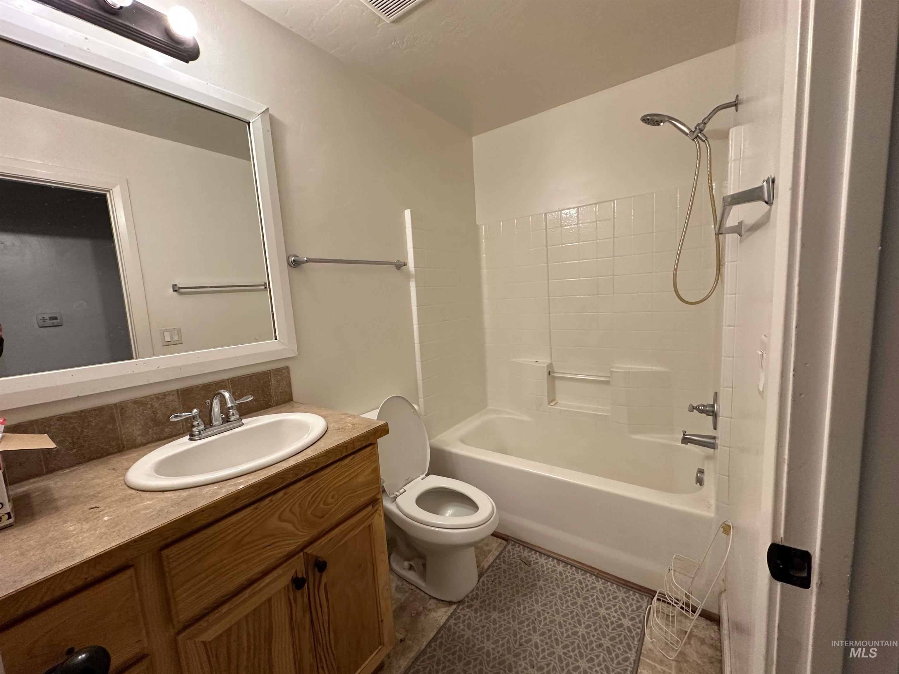Bathroom featuring vanity and shower / tub combination