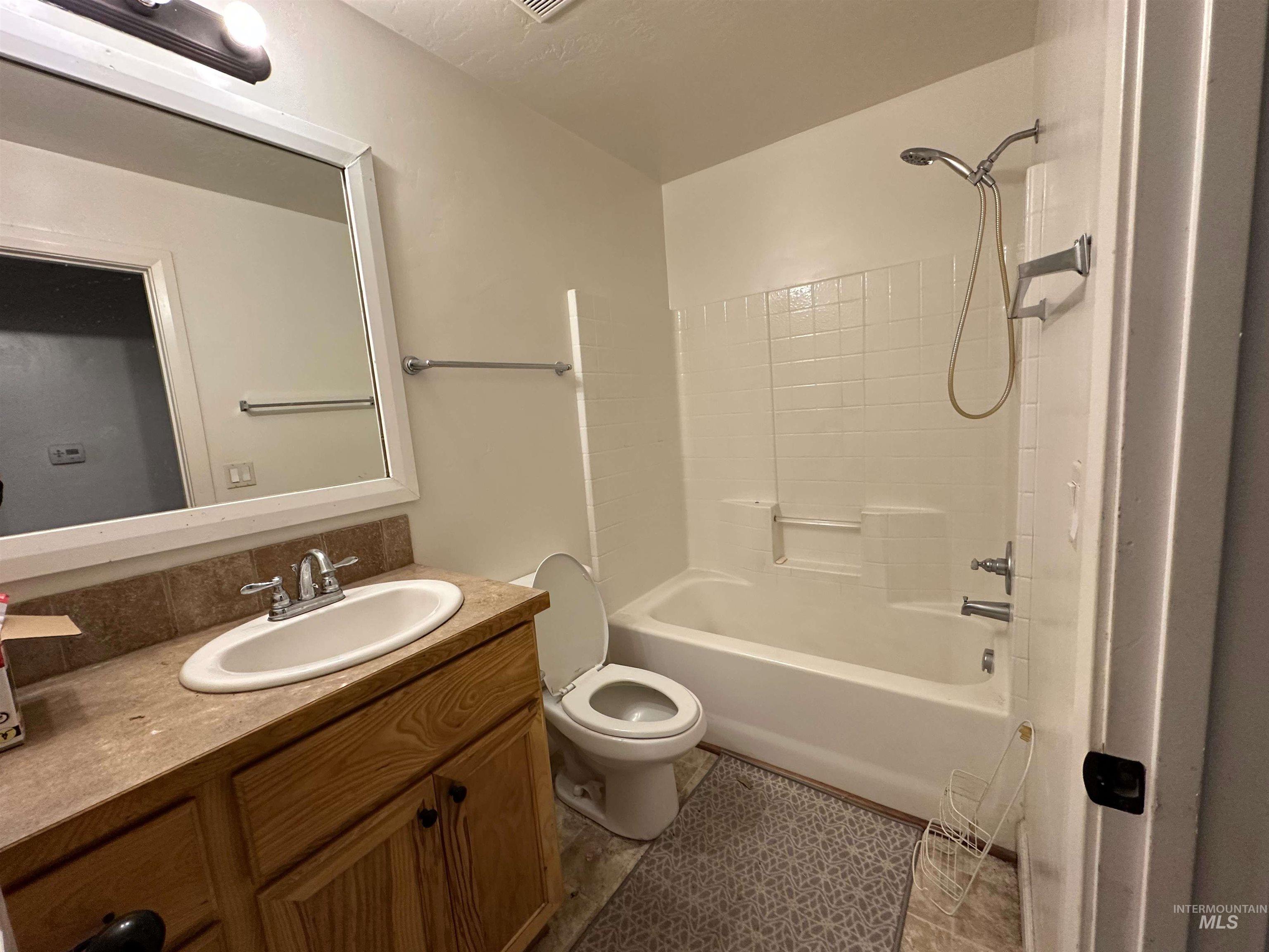 Full bath featuring vanity and shower / bathtub combination