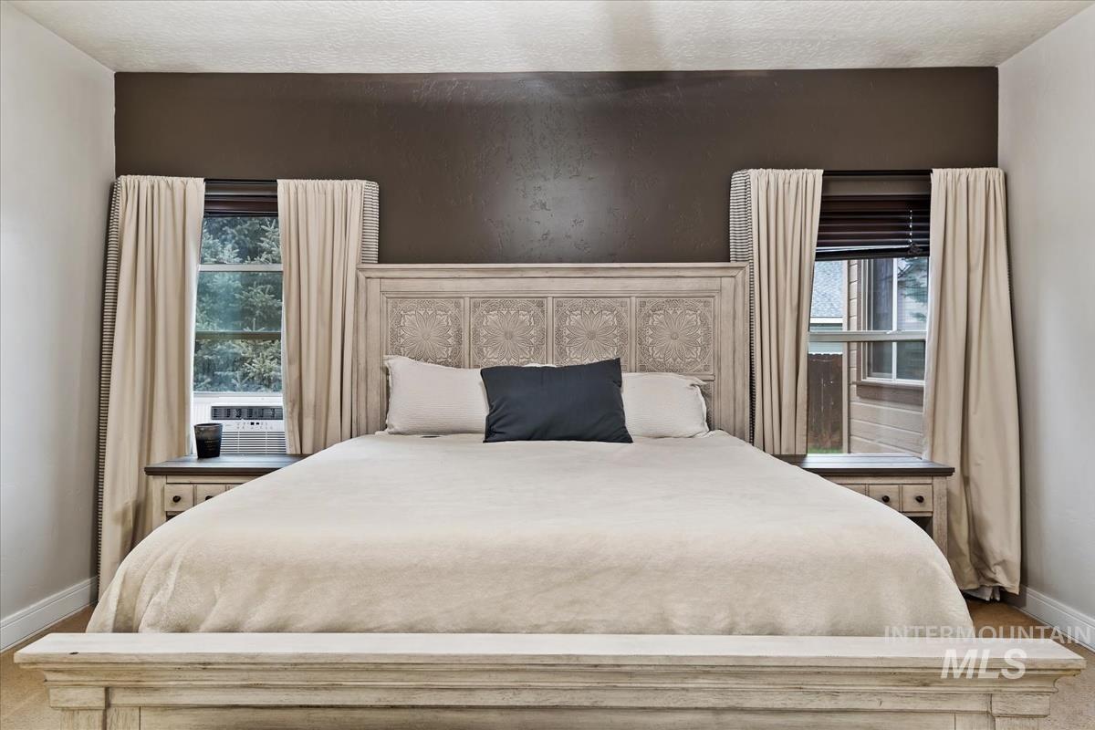 Bedroom featuring multiple windows