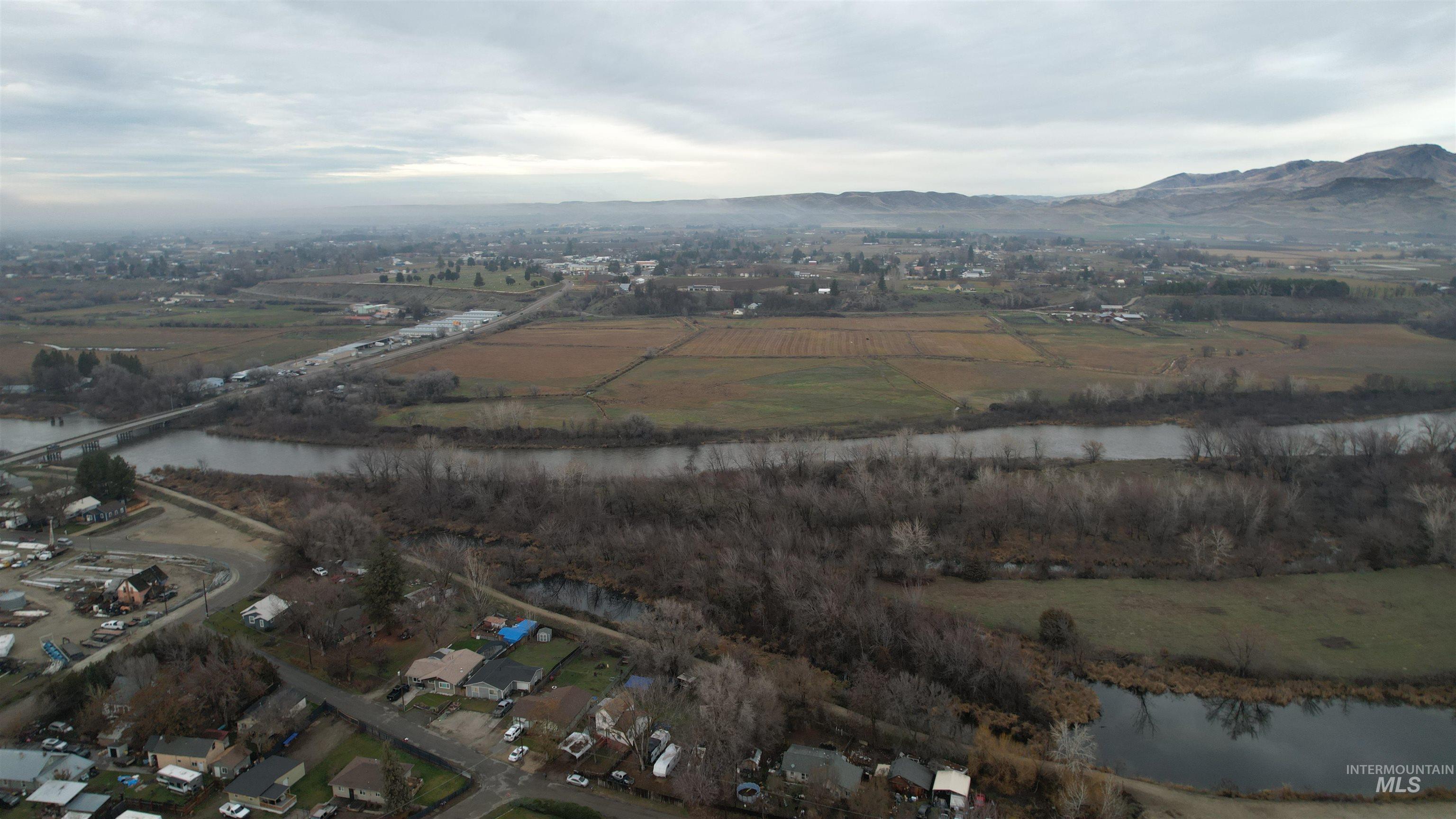Aerial view of property and surrounding area featuring a water and mountain view