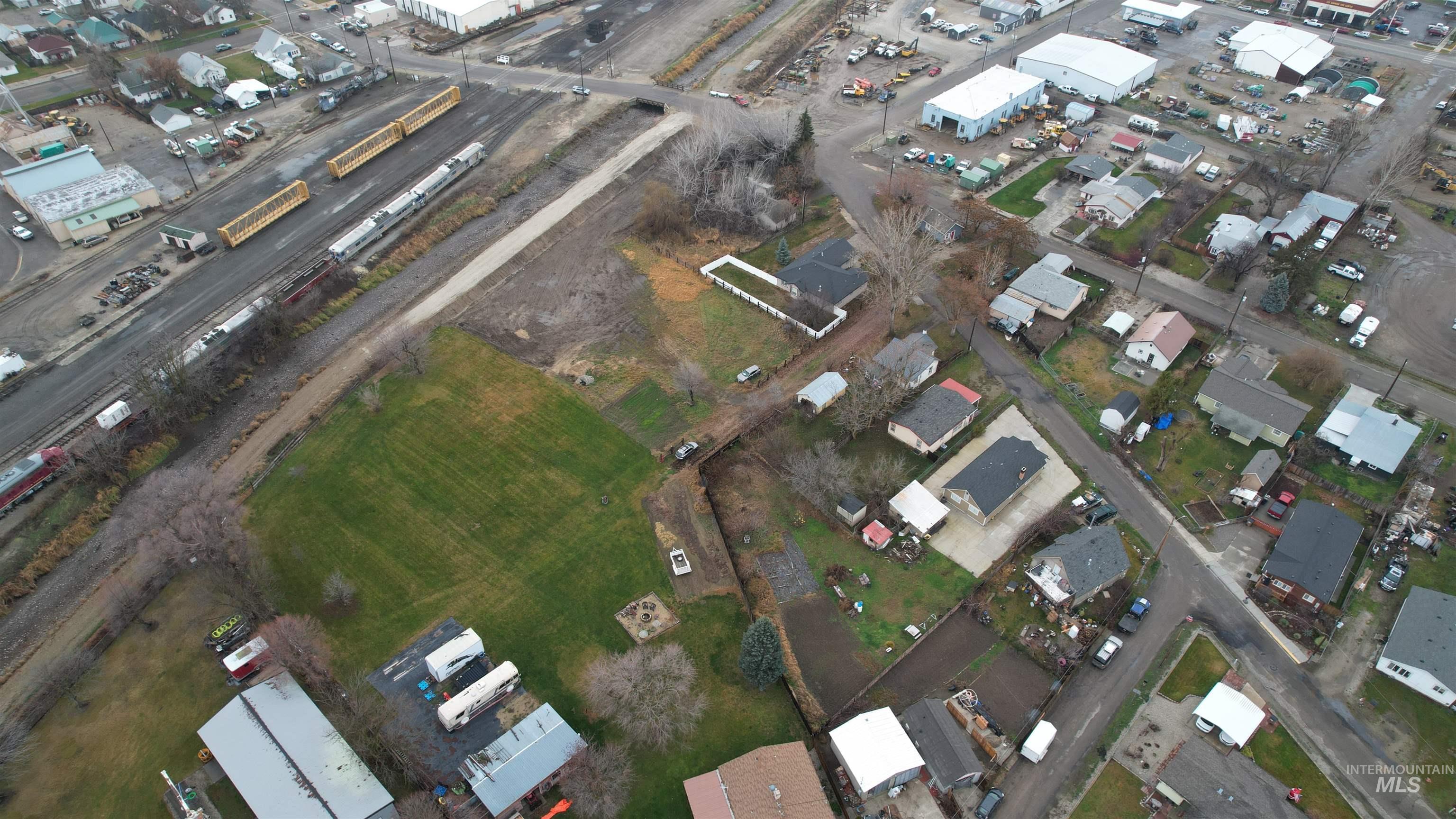 Aerial view of property and surrounding area featuring an industrial area