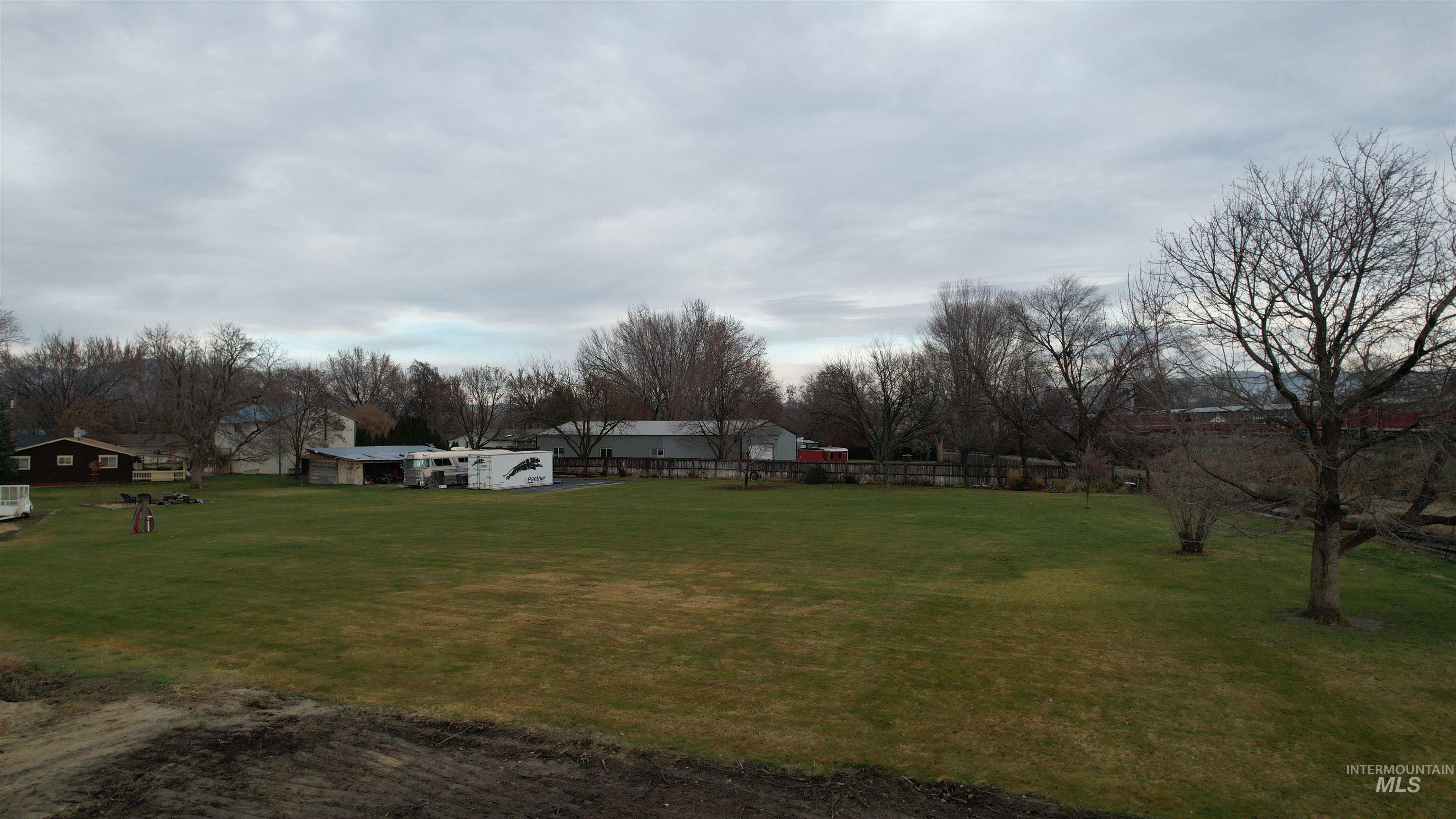 View of green lawn with view of wooded area