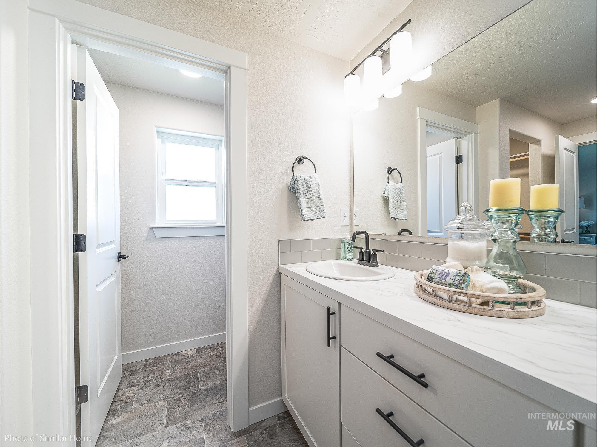 Bathroom with vanity and stone finish flooring