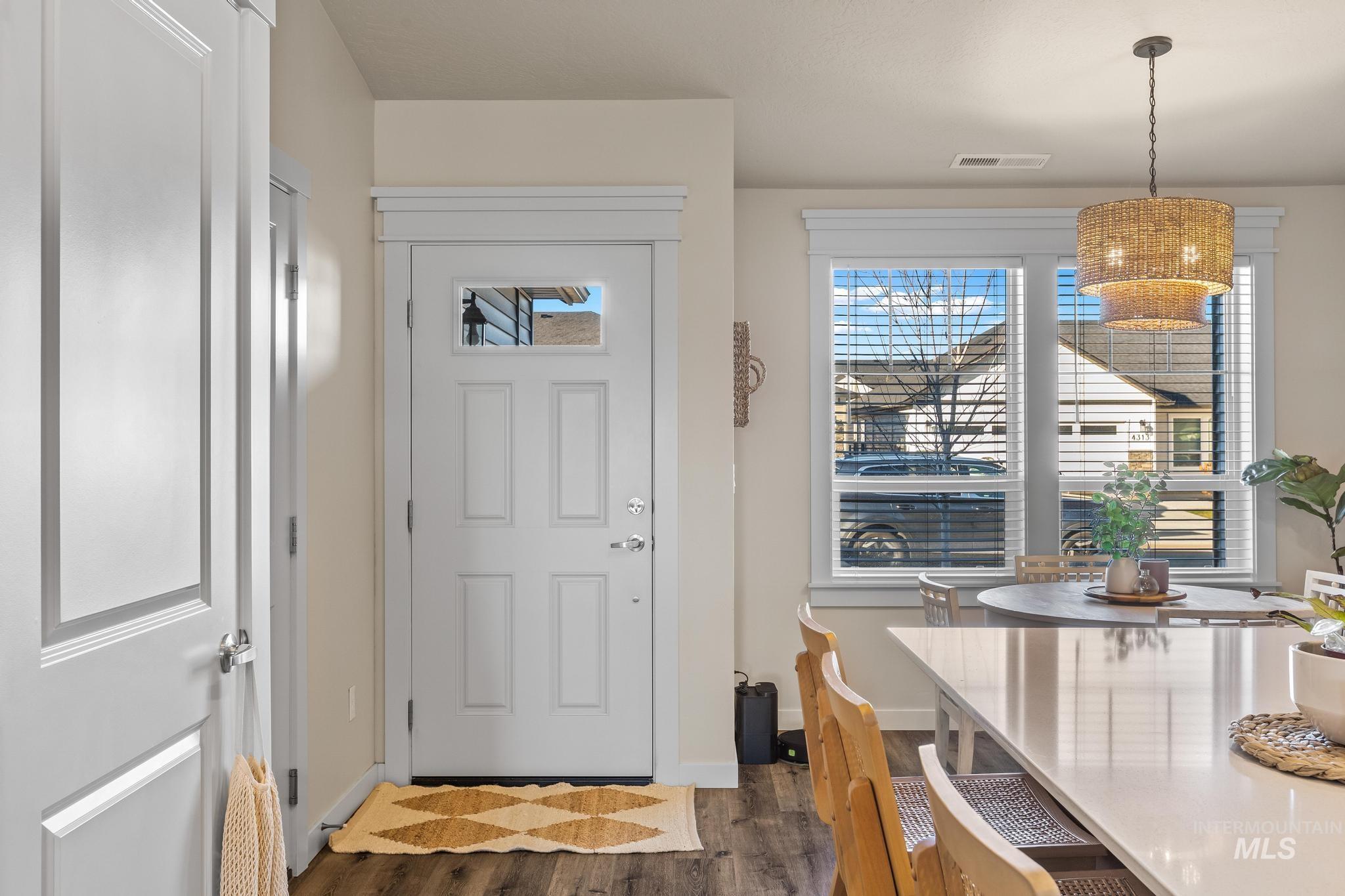 Foyer with dark wood-style flooring and healthy amount of natural light