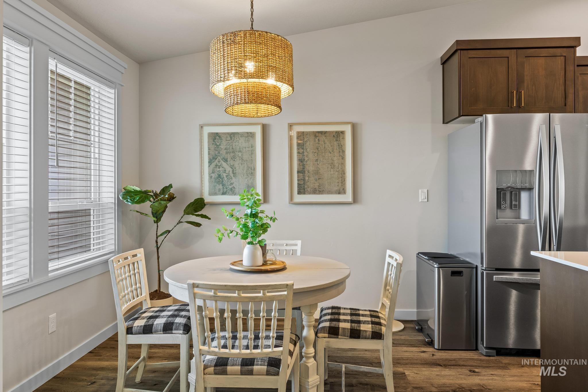 Dining room featuring dark wood-style flooring and baseboards