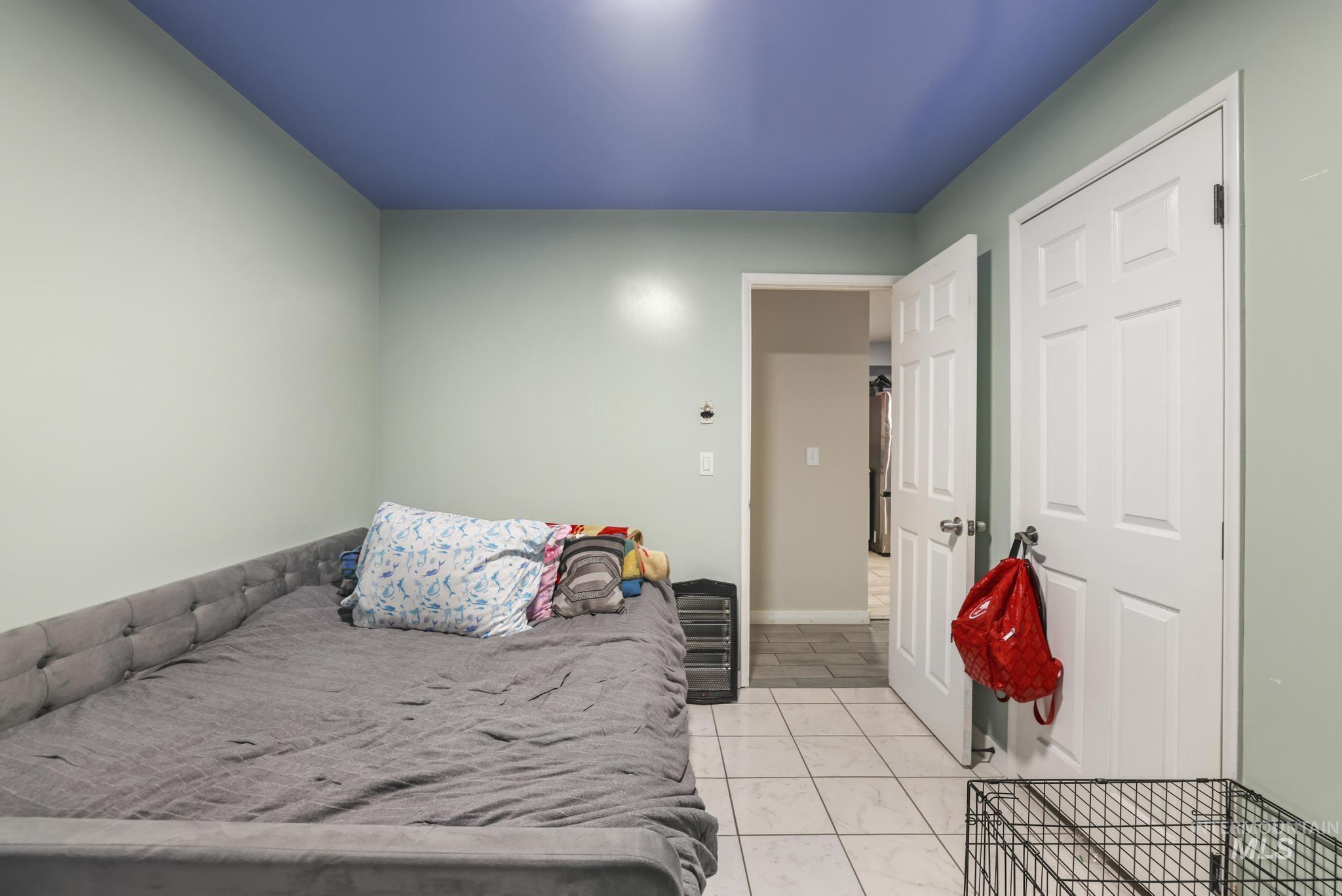 Bedroom with light tile patterned floors