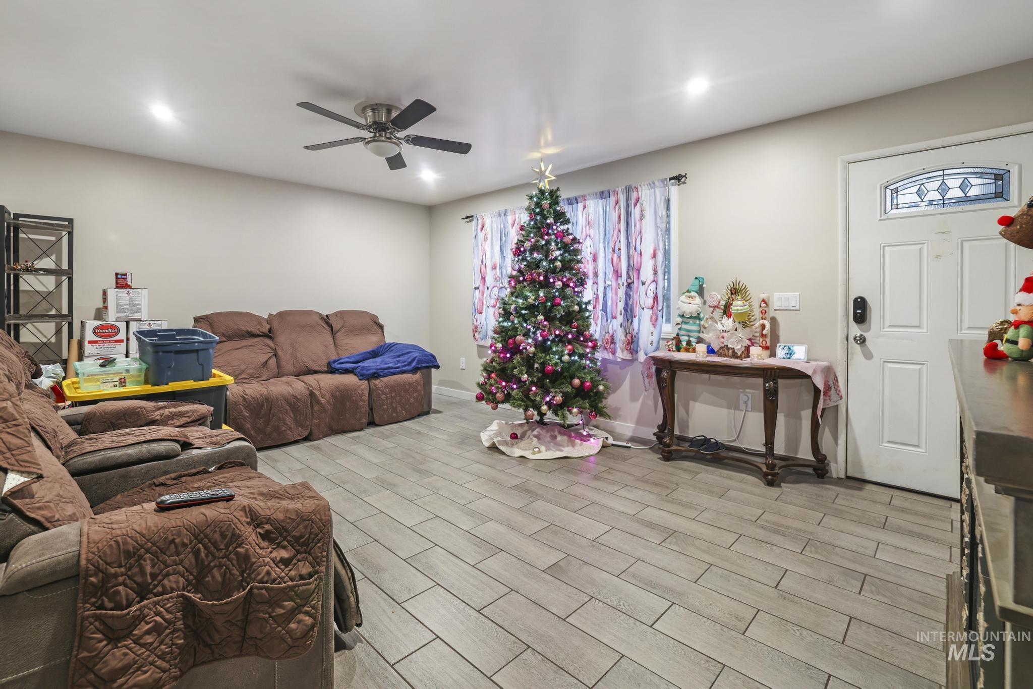 Living area featuring wood finish floors, recessed lighting, and ceiling fan