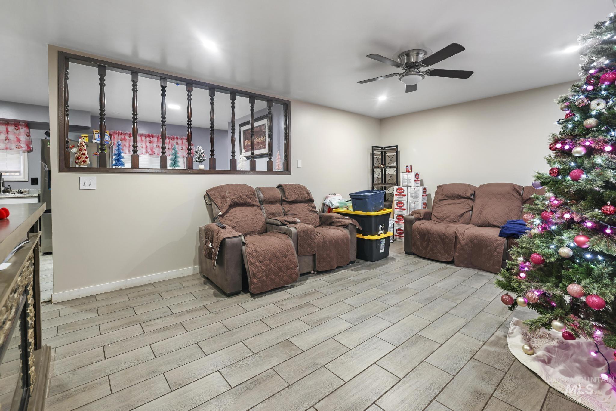 Living room featuring wood tiled floors and ceiling fan