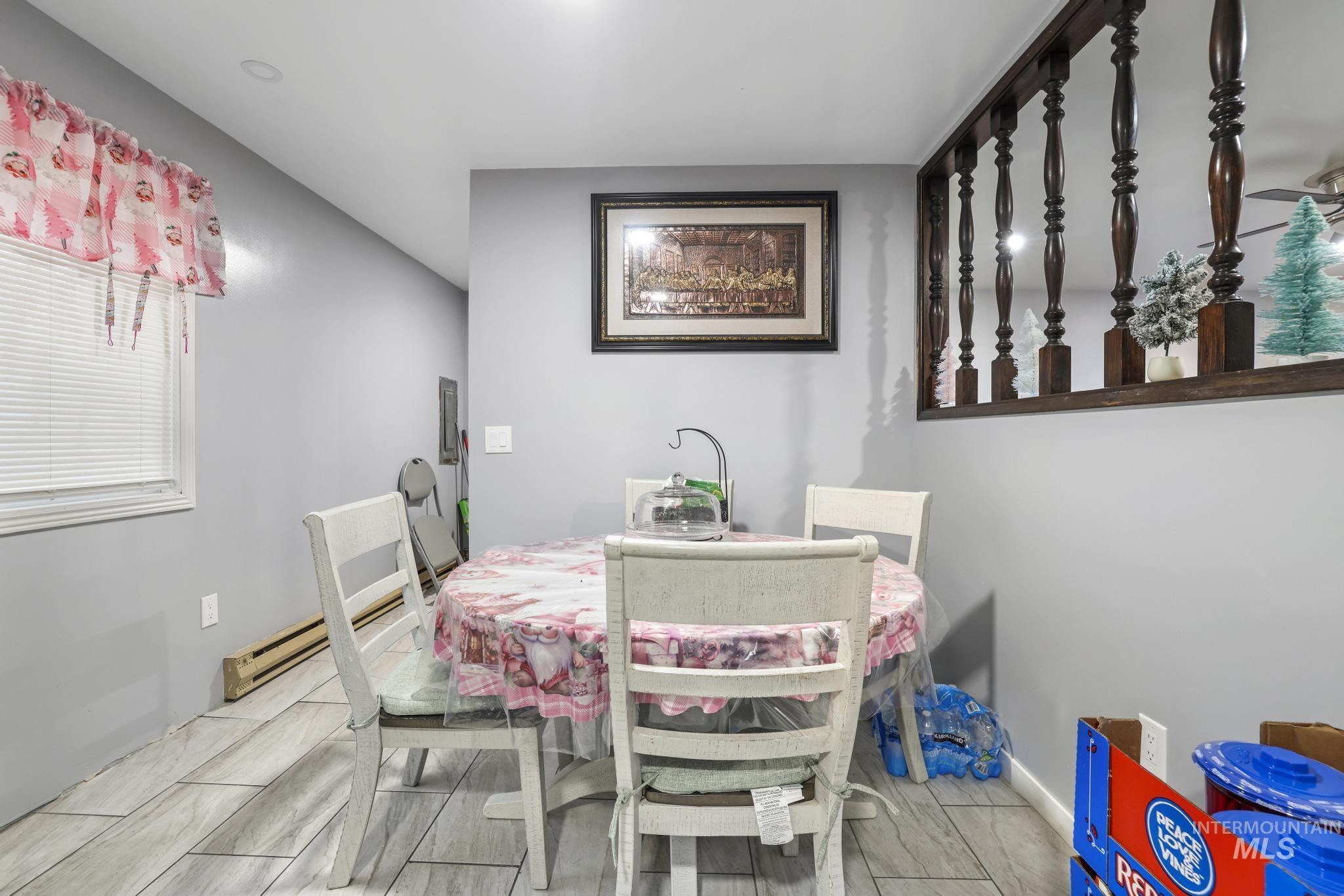 Dining area with wood finish floors and a baseboard radiator