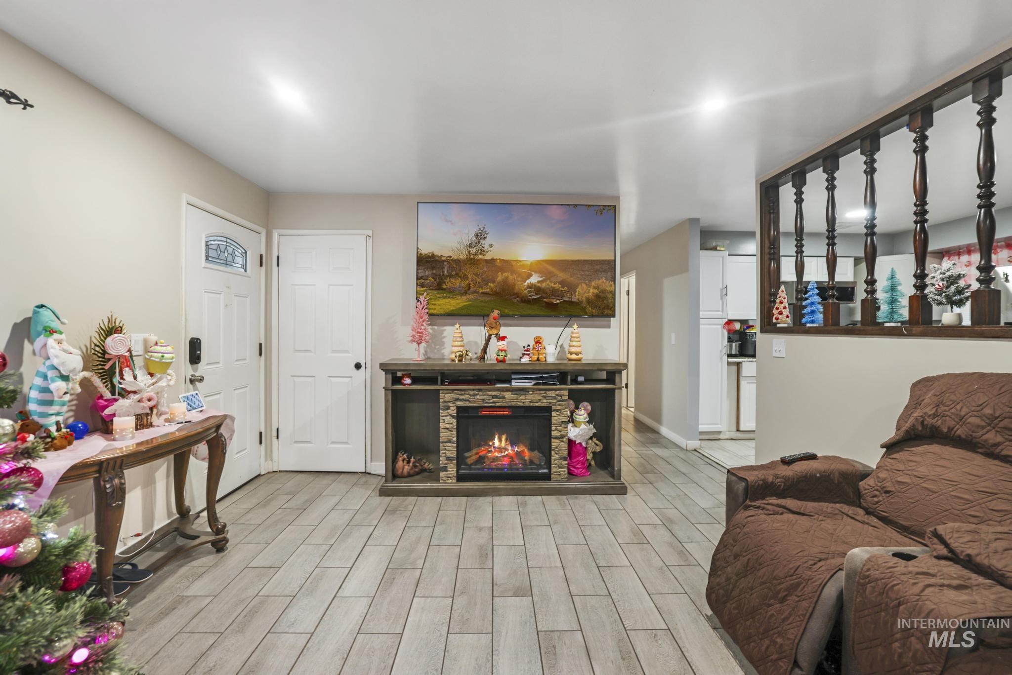 Living room with wood tiled floors and a fireplace