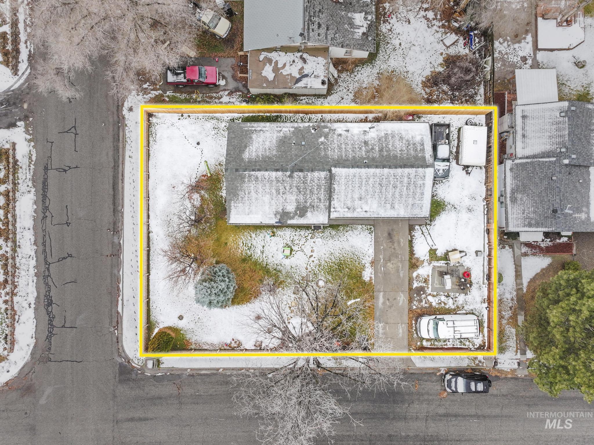 Aerial view of property and surrounding area featuring property parcel outlined