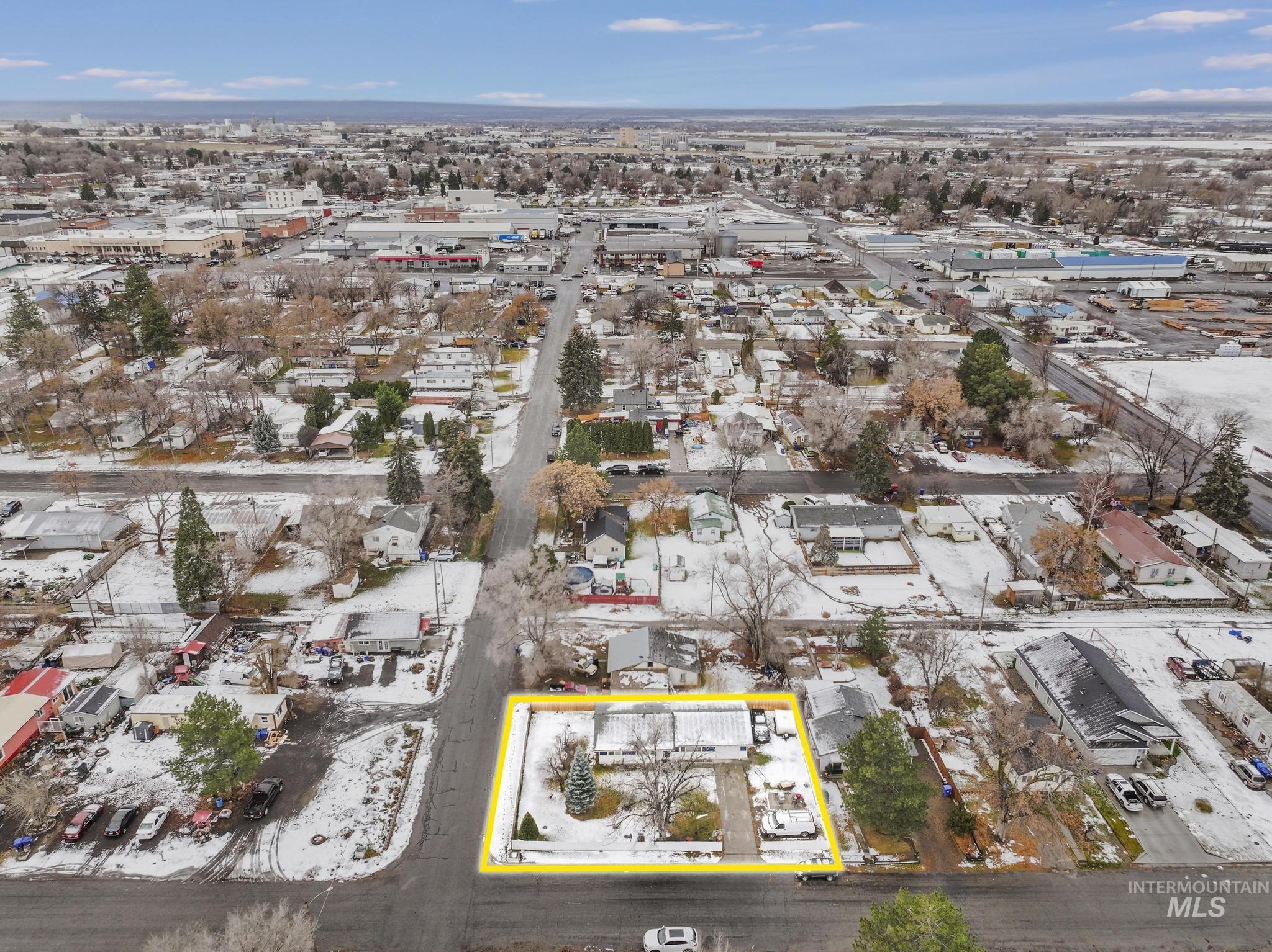Aerial view of property and surrounding area with property parcel outlined