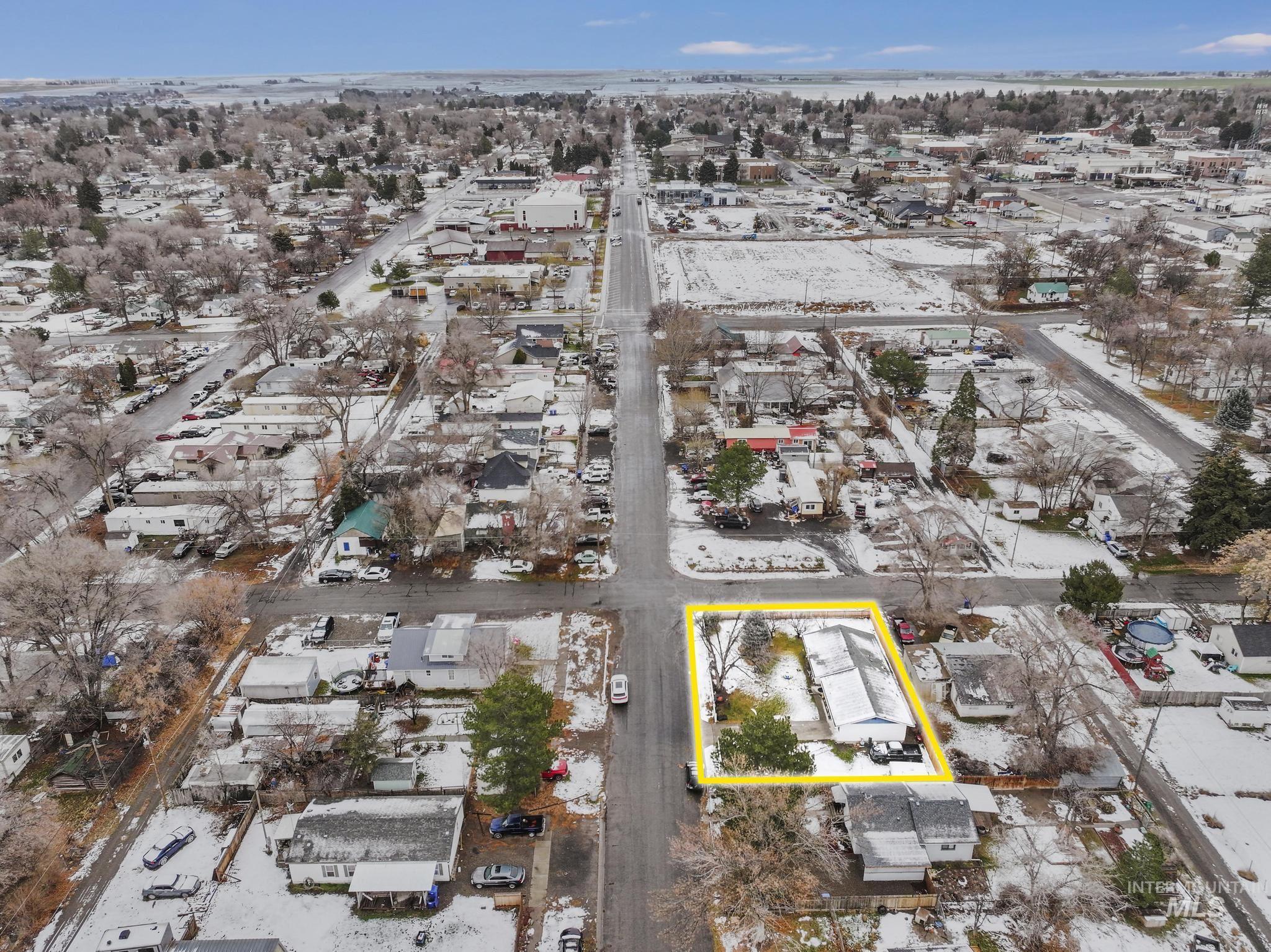 Snowy aerial view featuring property parcel outlined