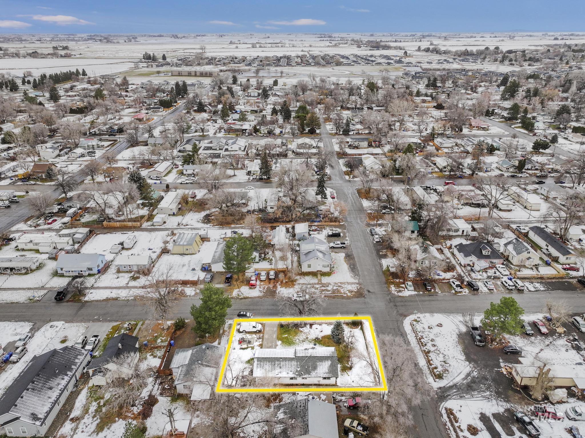 Snowy aerial view featuring property parcel outlined