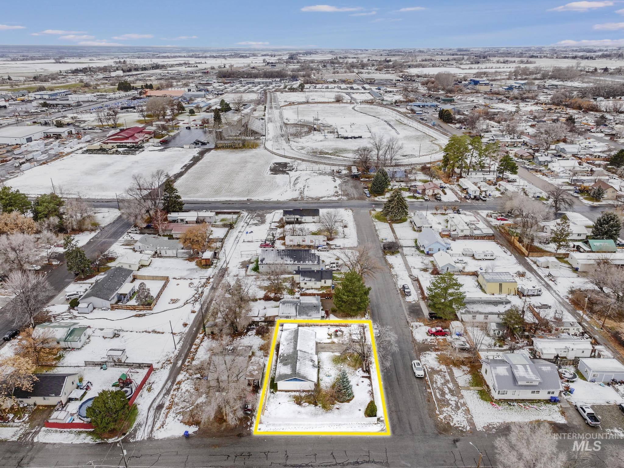 Snowy aerial view with property boundaries highlighted and a residential view