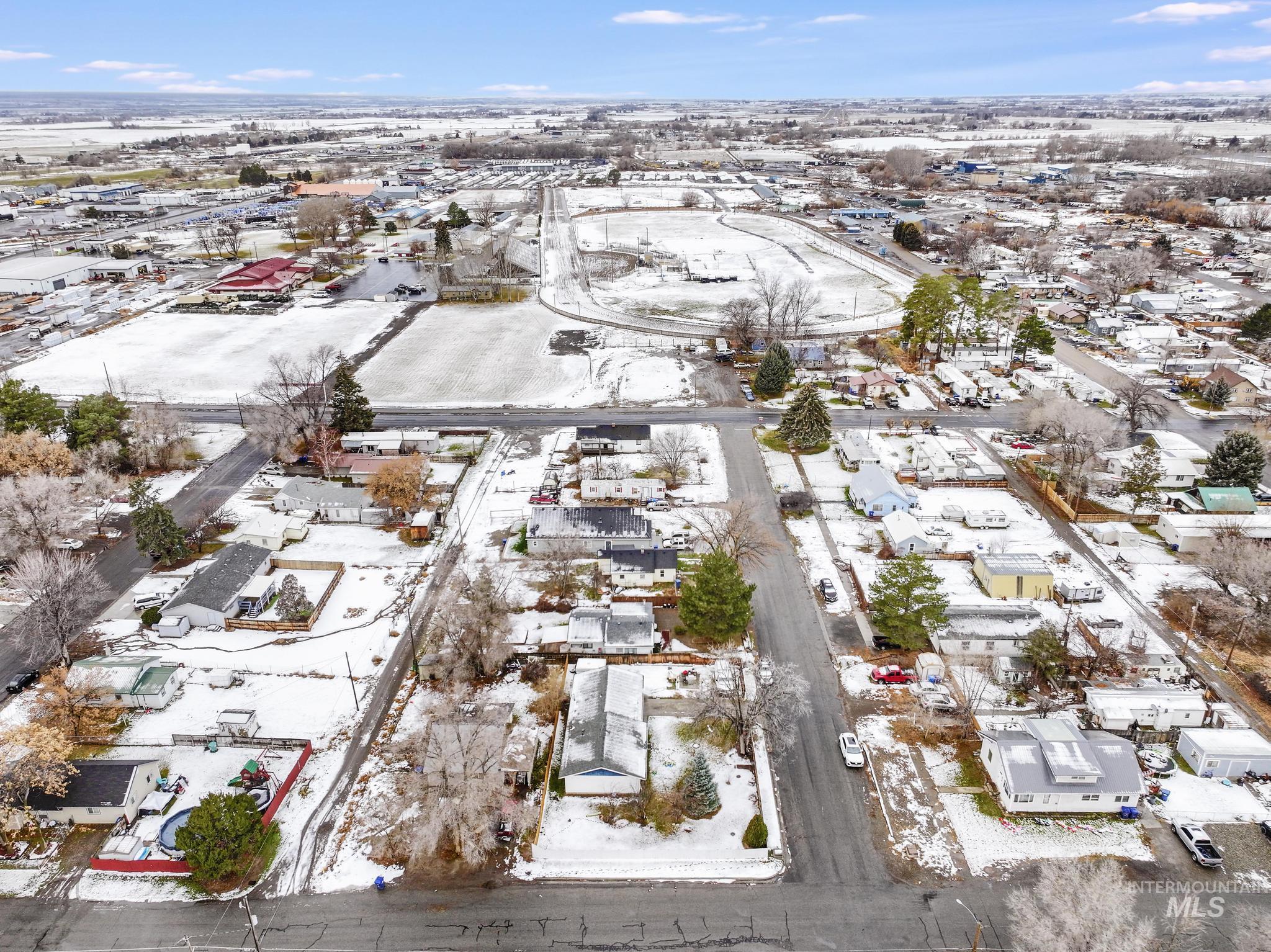 Snowy aerial view featuring a residential view
