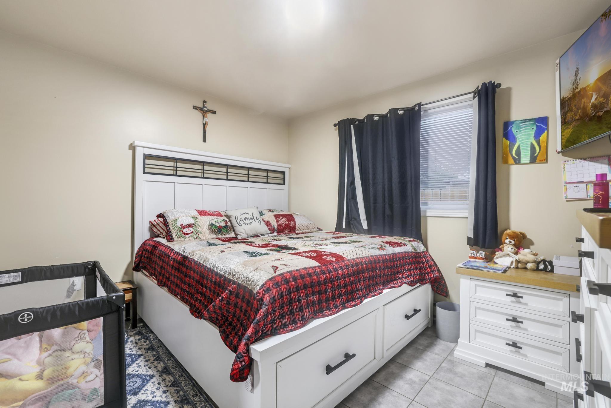 Bedroom featuring light tile patterned floors
