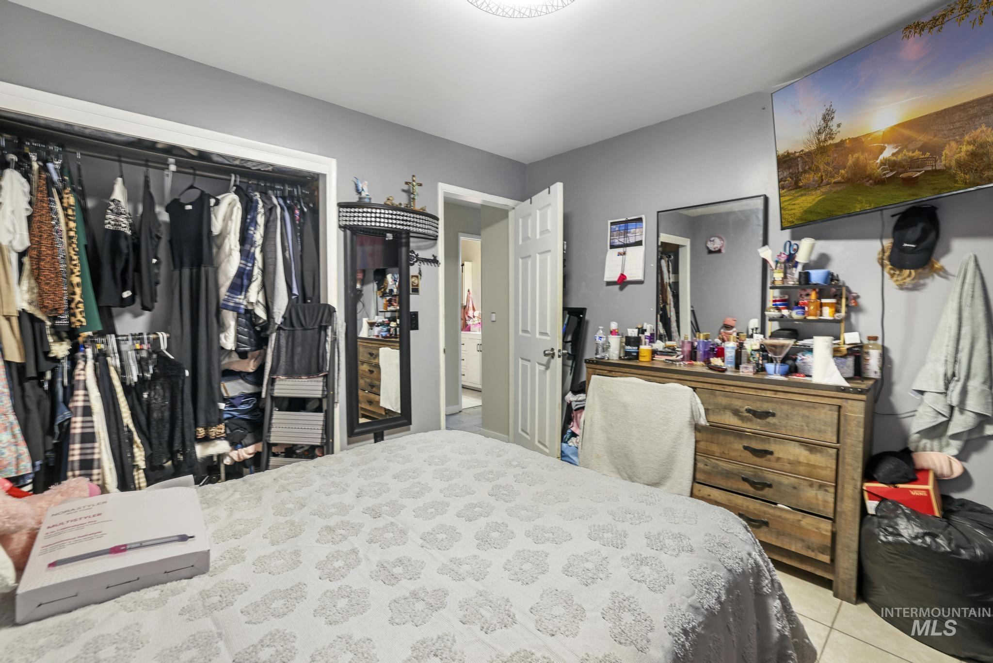 Bedroom with a closet and light tile patterned floors