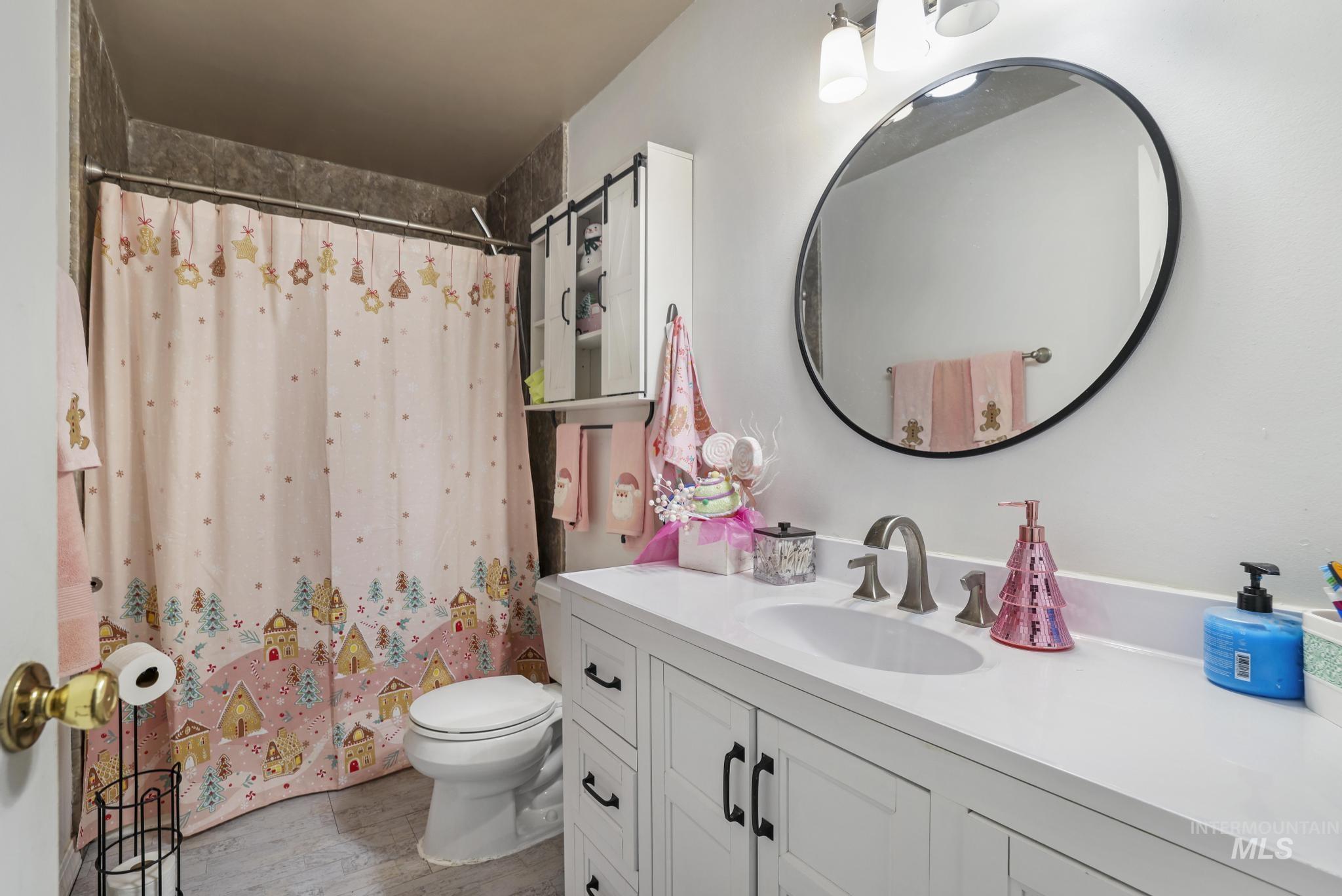 Bathroom featuring vanity and light wood-style floors