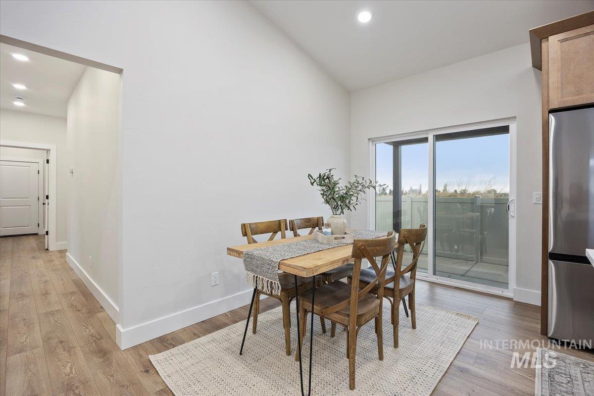 Dining space featuring light wood finished floors and recessed lighting